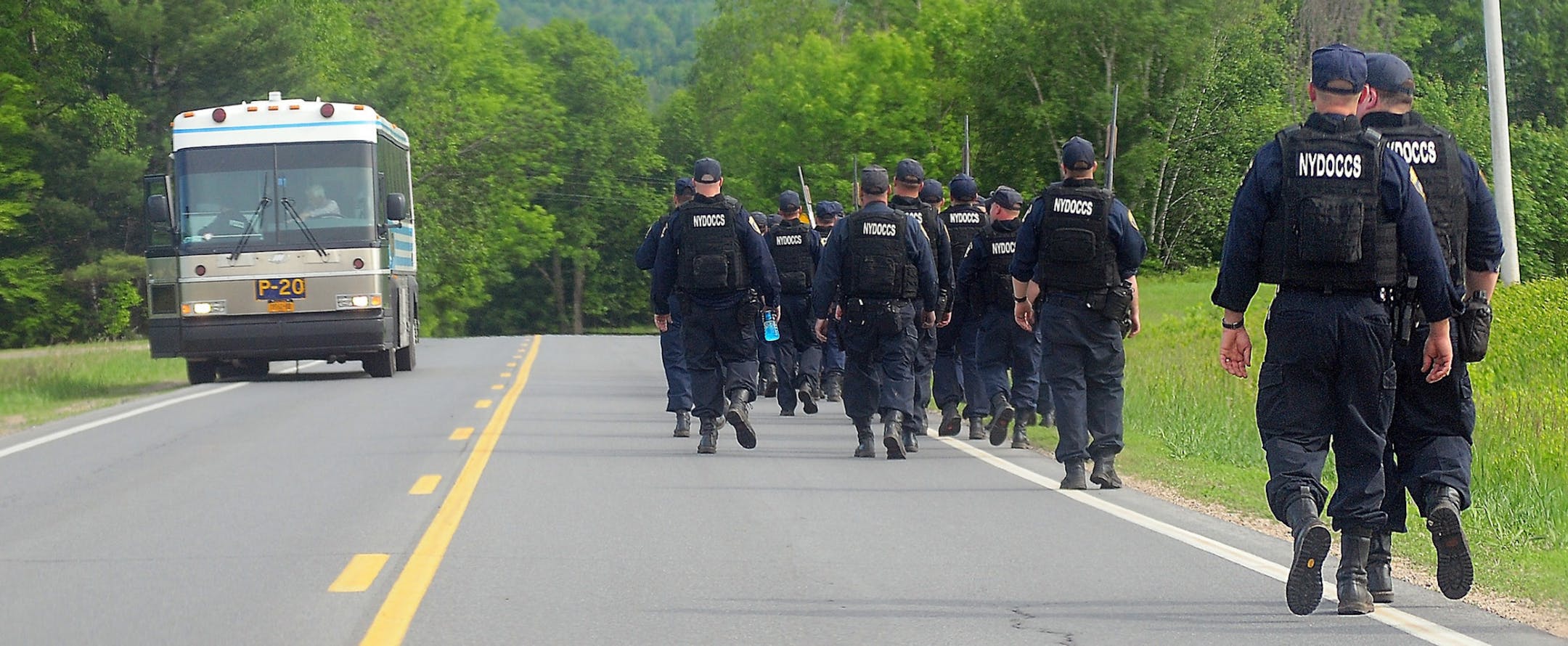 Law enforcement officers search for two escaped prisoners, Sunday, June 7, 2015, near Dannemora, N.Y. The two murderers who used power tools to escape from prison must have taken days to cut through steel walls and pipes and break through the bricks at the maximum-security prison, New York Gov. Andrew Cuomo said Sunday.