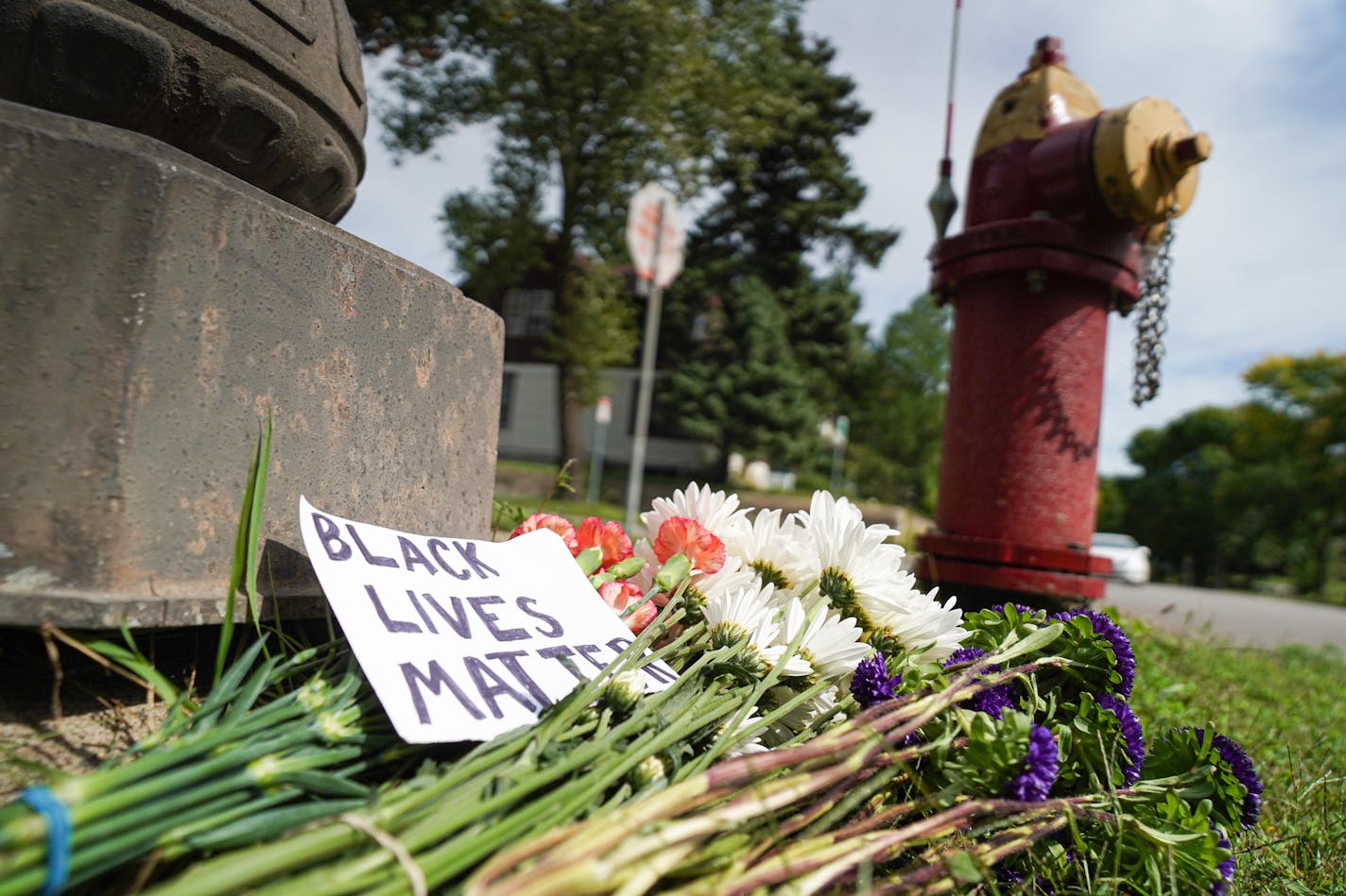 Streaks of blood in the street and two small bouquets of flowers were the only remnants Monday of the chaotic scene Sunday night at the site of an officer-involved shooting at Thomas Avenue W. and N. Griggs Street in St. Paul.