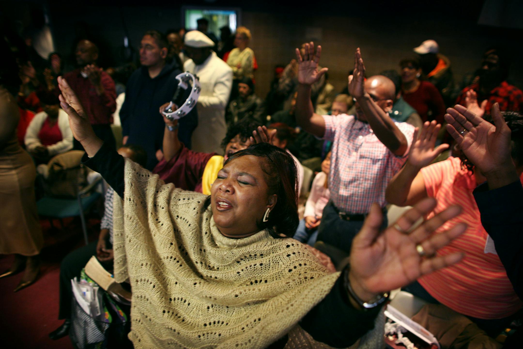 Karen Crosby of Minneapolis raised her hands in praise as she worshiped with others at Sunday services at the Salvation Army's Harbor Light chapel.