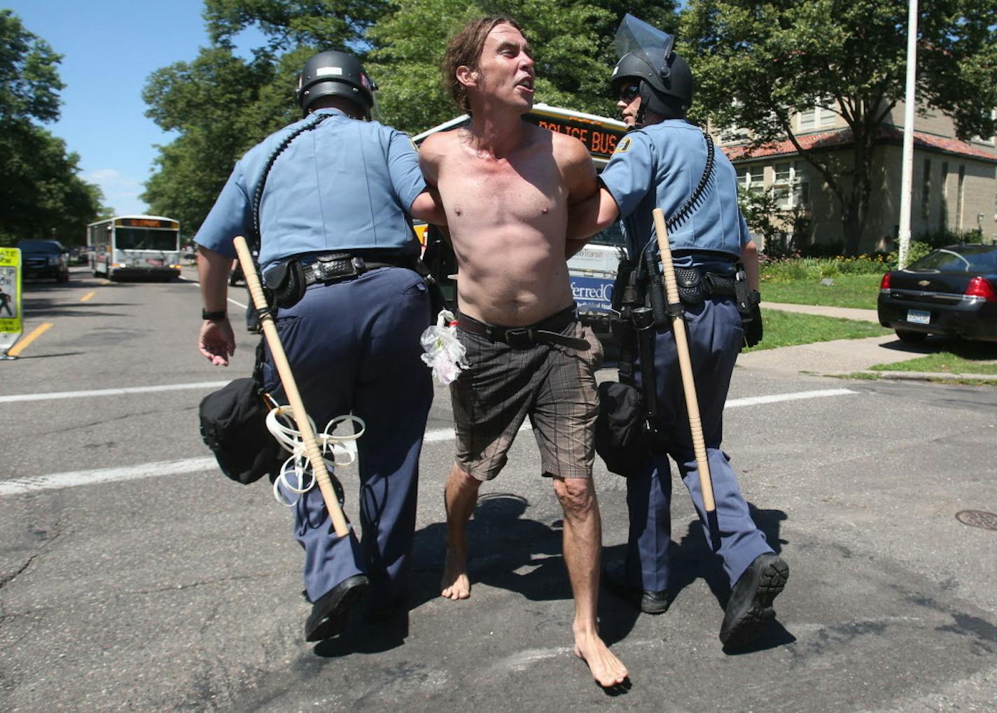 A protestor yells as his is led to a nearby bus by St. Paul police officers as arrests of protestors take place outside Gov. Mark Dayton's mansionTuesday, July 26, 2016, in St. Paul, MN.](DAVID JOLES/STARTRIBUNE)djoles@startribune Protesters were ordered Tuesday to clear the street and sidewalk in front of the governor's residence, where they have been since the fatal police shooting of Philando Castile nearly three weeks ago in neighboring Falcon Heights.**