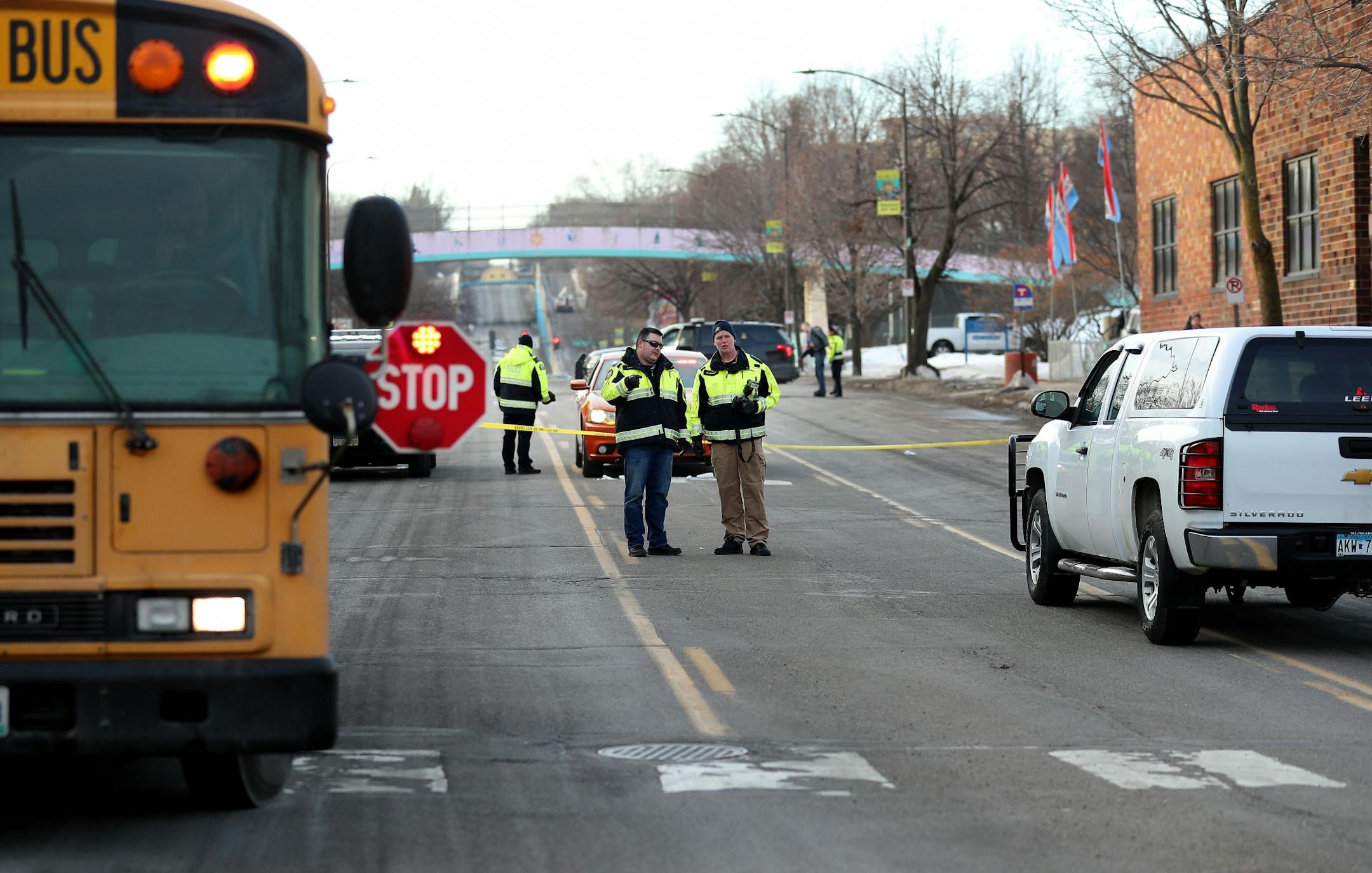 Law enforcement officers investigate the scene along Robert St. Thursday morning on St. Paul's west side.