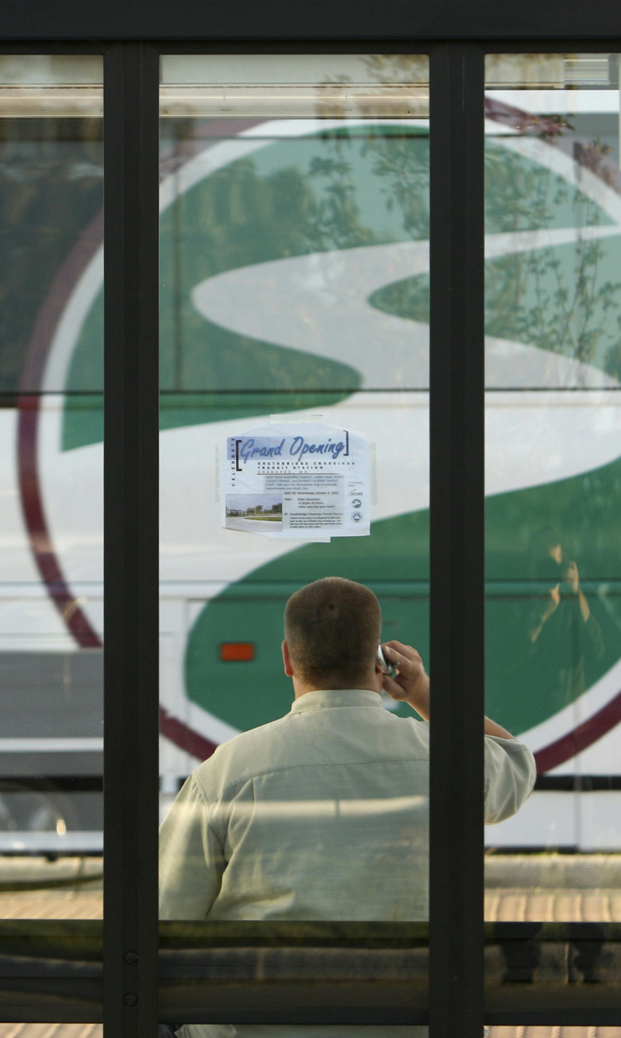 A man waits in a bus shelter as a Shakopee Transit BlueXpress bus arrived at the new Southbridge Crossings Transit Station in Shakopee Wednesday afternoon. GENERAL INFORMATION: JEFF WHEELER • jwheeler@startribune.com SHAKOPEE - 10/3/07 - A grand opening celebration was held Wednesday for the new Southbridge Crossings Transit Station in Shakopee. The bus service into Minneapolis and back has been up and running for three months, but on Wednesday local tranist officials greeted commuters wi