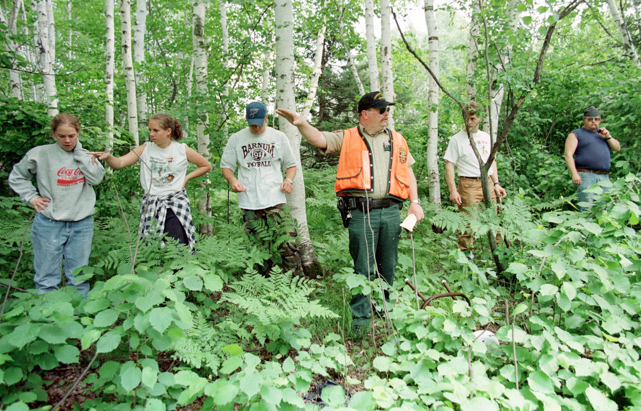 DNR enforcement officer Rich Hansen directed volunteers as they searched a woods along County Line Road east of where the suspect in the disappearance of Katie Poirier had a trailer.