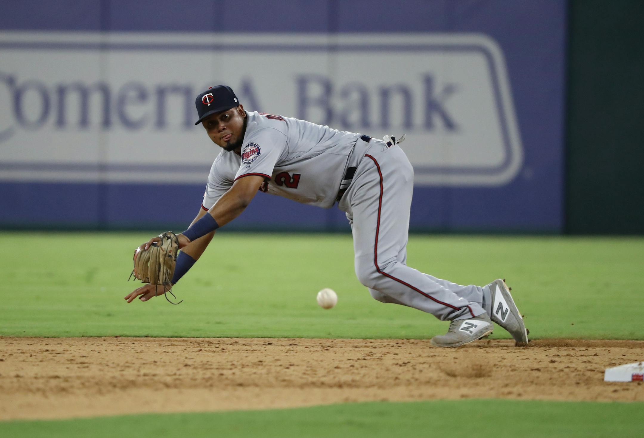 Minnesota Twins second baseman Luis Arraez (2) is unable to field a run-scoring single by Texas Rangers' Elvis Andrus in the fifth inning of a baseball game in Arlington, Texas, Thursday, Aug. 15, 2019. The hit scored Jose Trevino. (AP Photo/Tony Gutierrez)