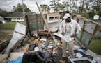 Tony Thompson looks at damage at his mobile home, Sunday, Sept. 16, 2018, in Newport, N.C., following Hurricane Florence. Thompson lost his home and m