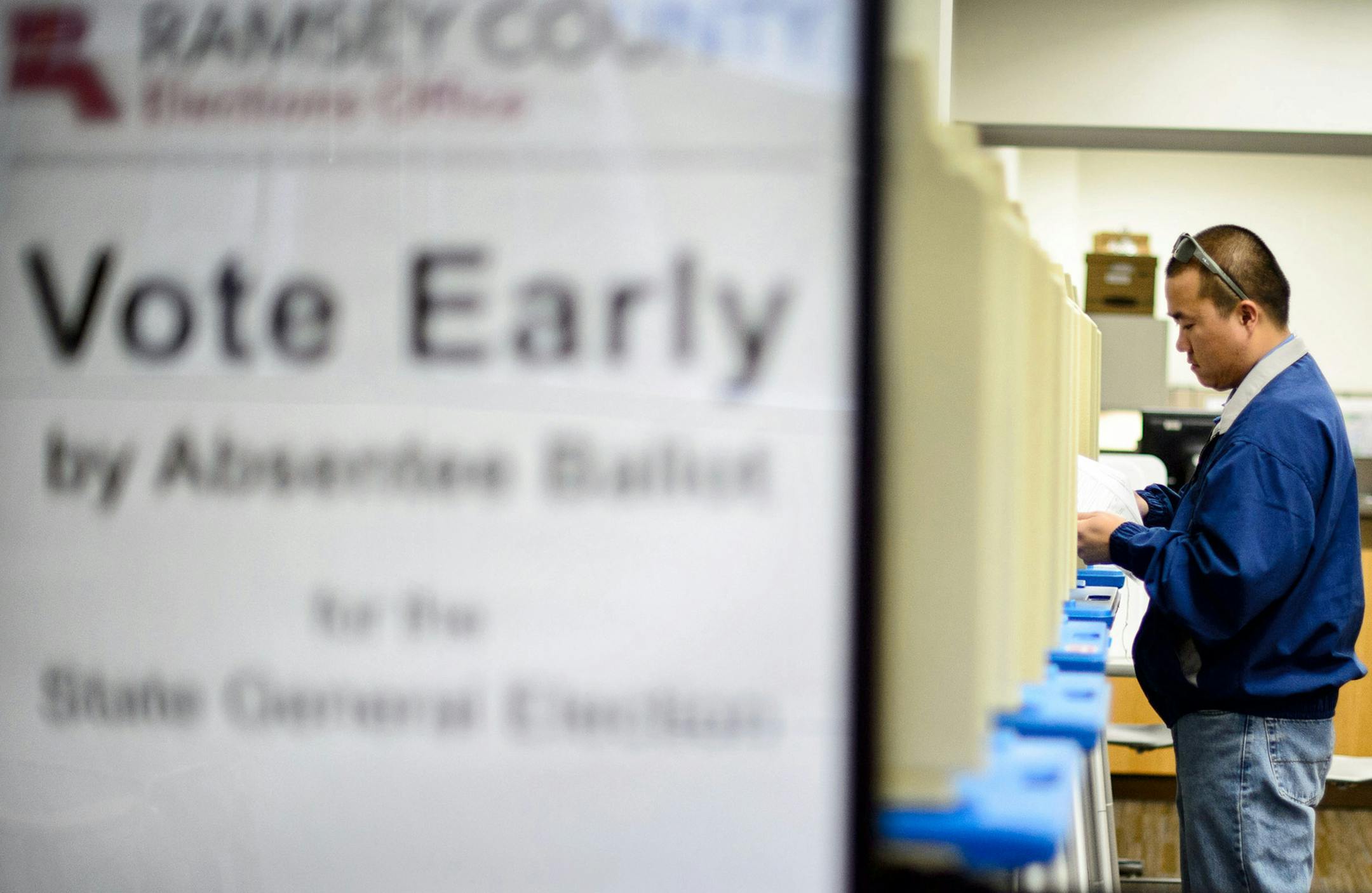 Ko Vang of St. Paul filled out his ballot. ] GLEN STUBBE * gstubbe@startribune.com Processing absentee ballots at the Ramsey County elections office Monday October 20, 2014 ORG XMIT: MIN1410201226000367