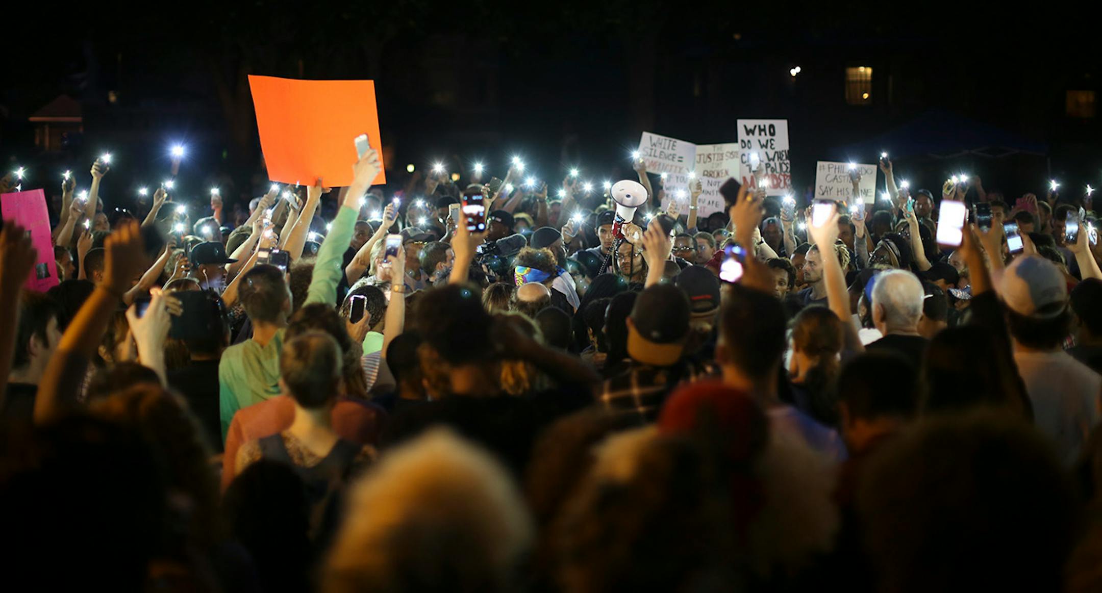 The crowd listening to speakers in front of the Governor's Residence Thursday night illuminated the scene with their cell phones.