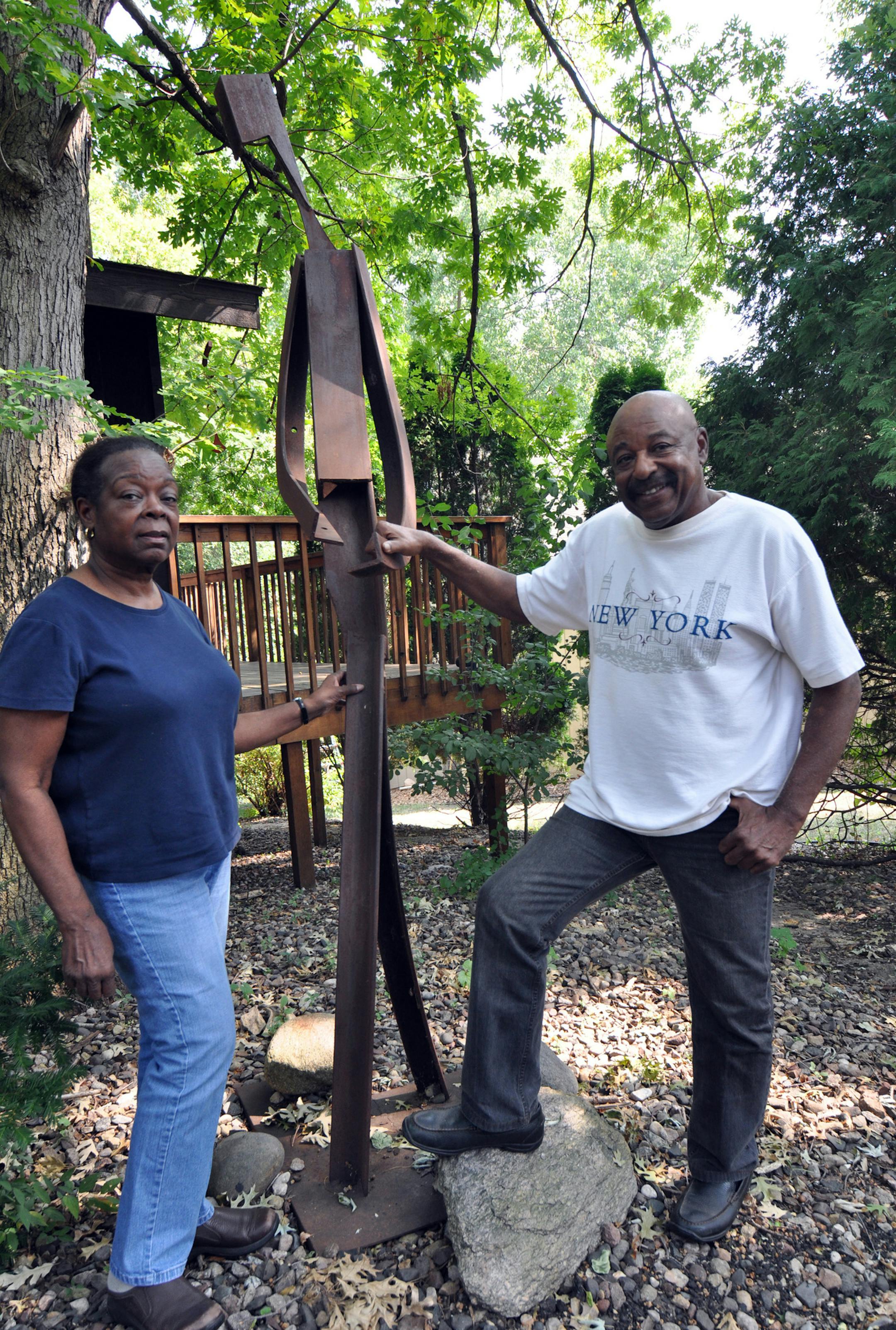 Photo by Liz Rolfsmeier Eagan artists Rose J. Smith and Melvin R. Smith stand next to his statue "Lamar," which is modeled after his brother, in front of their Eagan home.