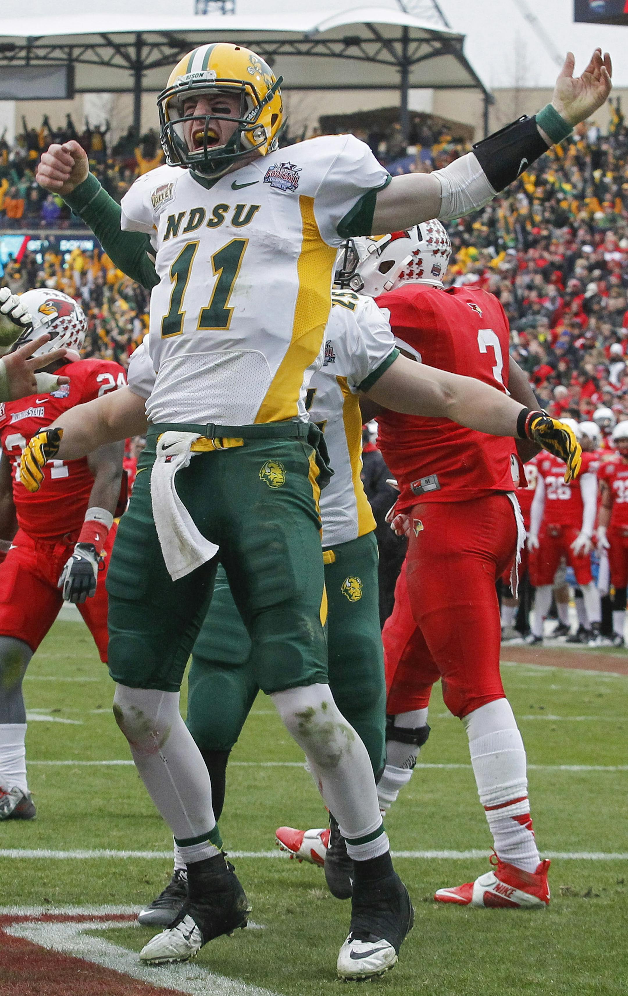 North Dakota State quarterback Carson Wentz (11) celebrates with his team after scoring the go-ahead touchdown against Illinois State during the FCS Championship NCAA college football game Saturday, Jan. 10, 2015, in Frisco, Texas. North Dakota State won the game 29-27 for their fourth straight national championship. (AP Photo/Tim Sharp) ORG XMIT: OTKTXTS129.jpg ORG XMIT: MIN1508282331370125