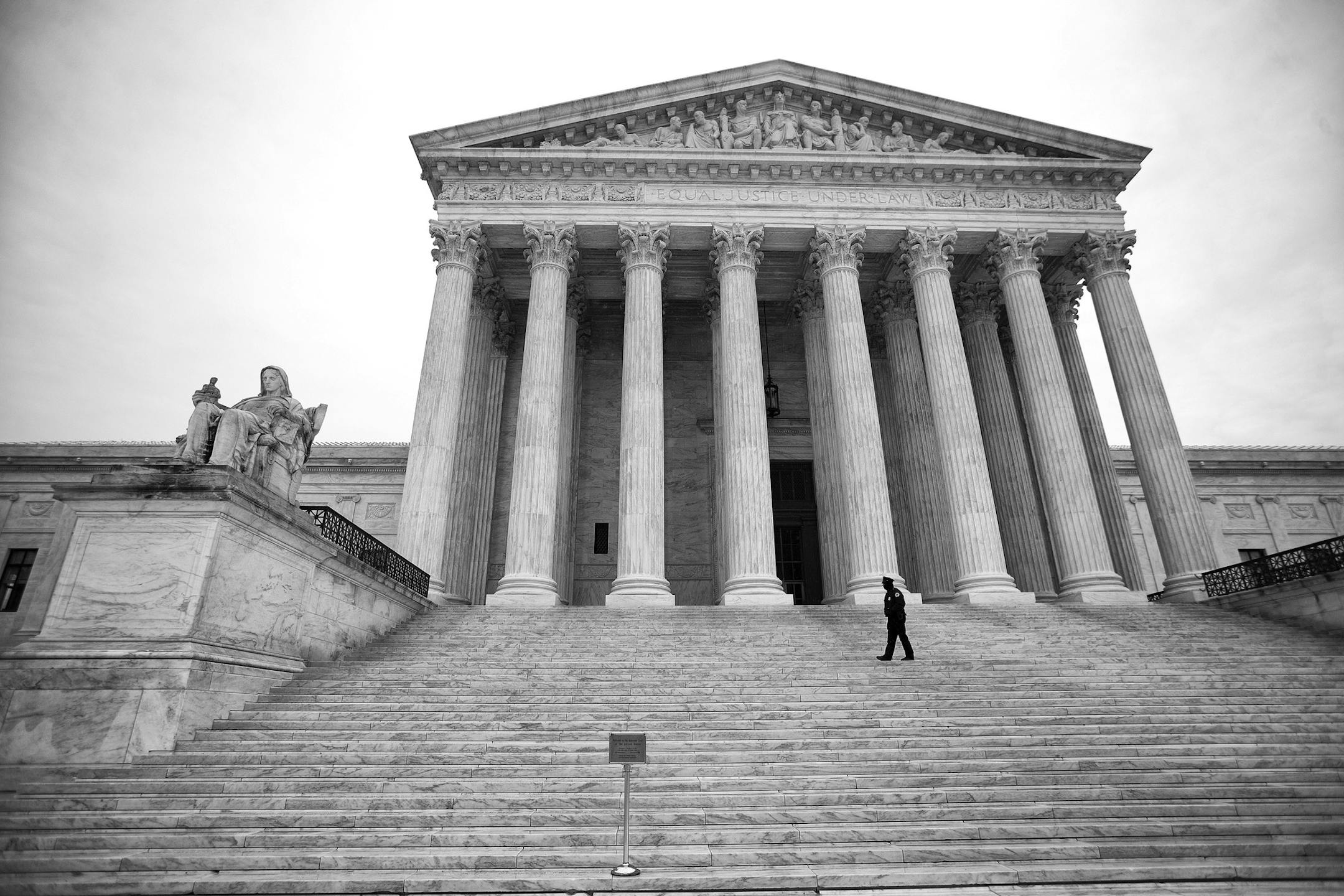 An officer patrols the steps of the Supreme Court building, on Capitol Hill in Washington, March 3, 2015.