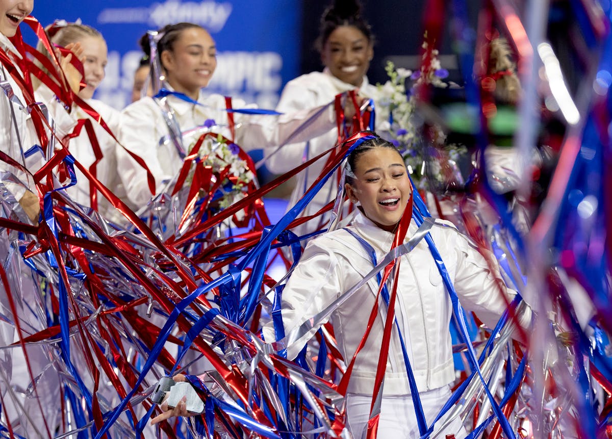 St. Paul's Suni Lee celebrates with teammates after being introduced as a member of the U.S. Olympic team on Sunday after the U.S. gymnastics Olympic 
