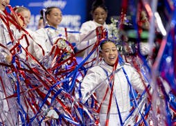 Suni Lee celebrates with teammates after being introduced as a member of the USA Olympic team on Sunday after the U.S. Gymnastics Olympic Trials concl
