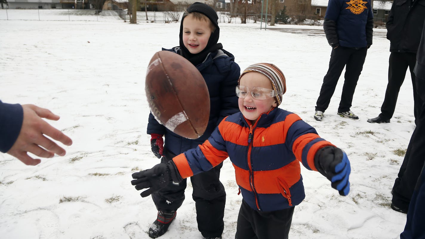 Micah Wicklund, right, and his brother Caleb Wicklund played with a football at Kentucky Park in Crystal.