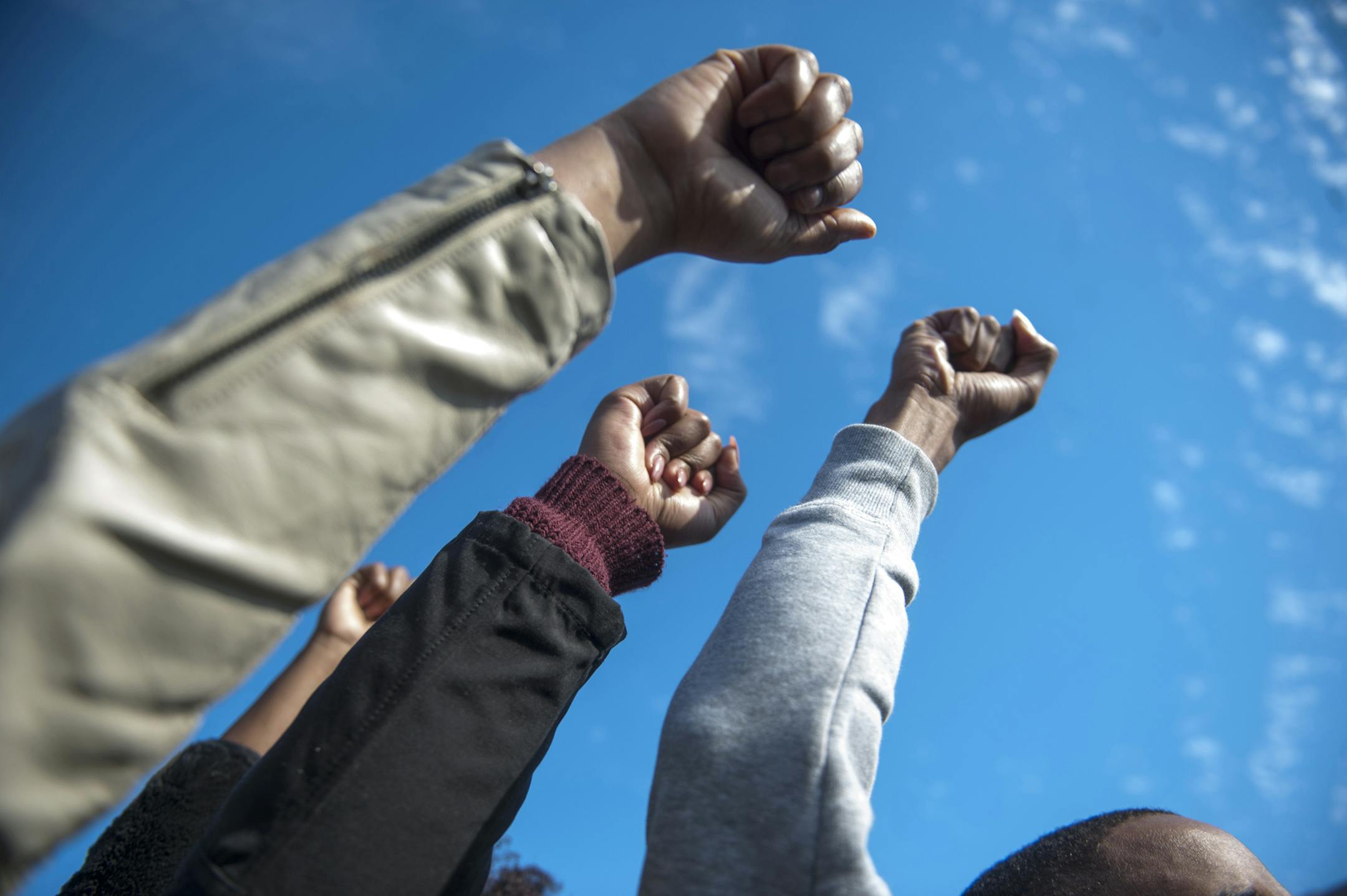Protesters raise their fists to celebrate Tim Wolfe's resignation during the Concerned Students 1950 protest on Monday, Nov. 9 2015, in Columbia, Mo. (Michael Cali/San Diego Union-Tribune/TNS) ORG XMIT: 1176357