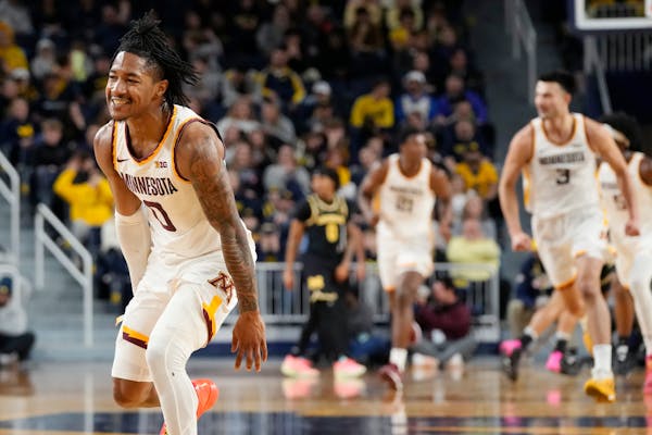 Minnesota guard Elijah Hawkins (0) reacts after a three-point basket during the second half of an NCAA college basketball game against Michigan, Thurs