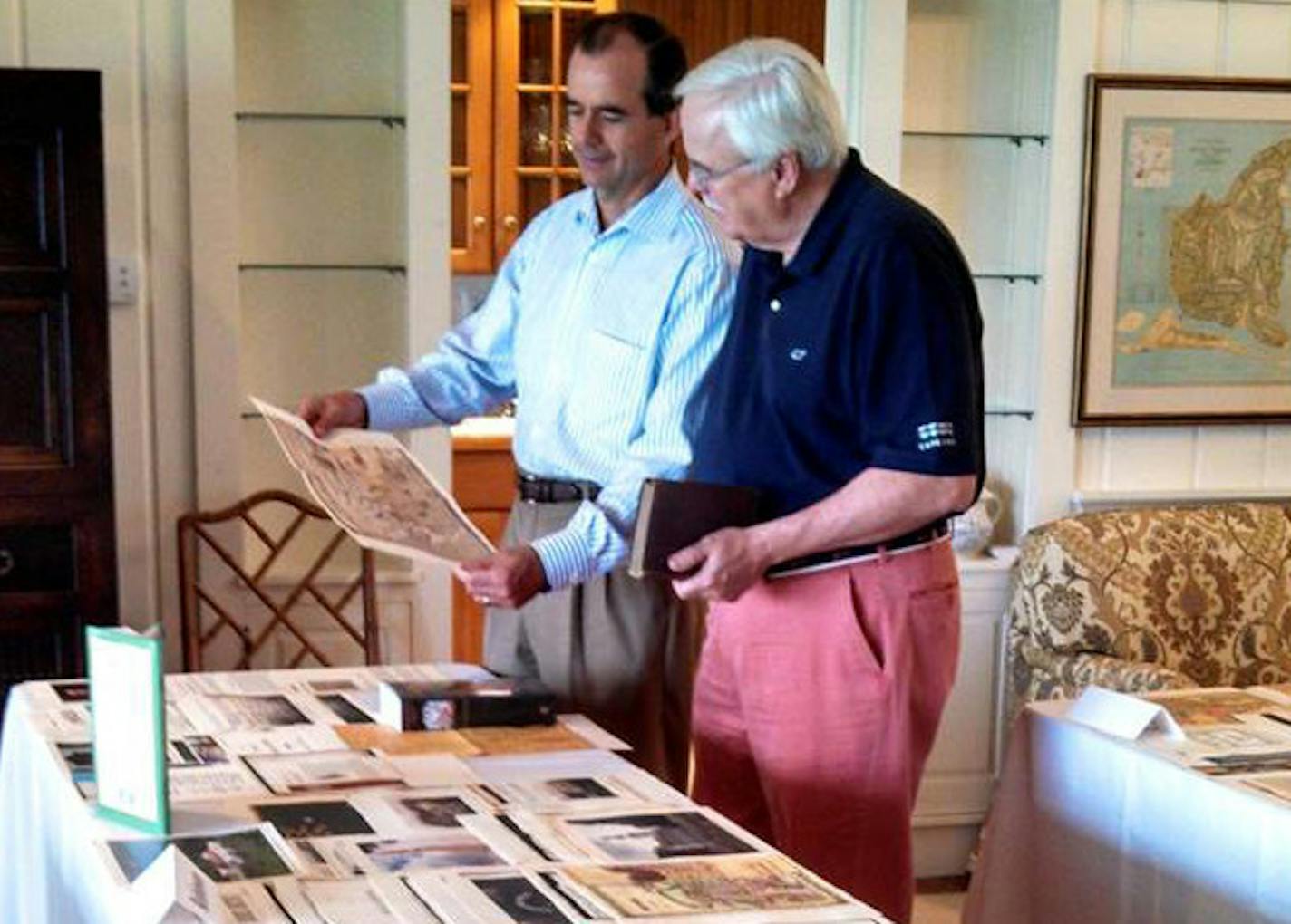 Abbot Downing chief historian Andy Anderson (at right) and director Matt Robertson review a client&#xed;s family history in Massachusetts. (Photo courtesy: Abbot Downing)