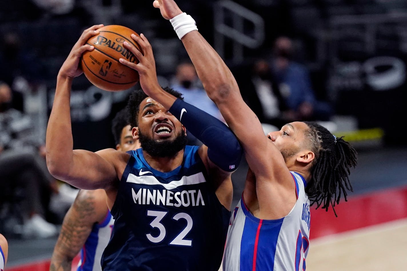 Timberwolves center Karl-Anthony Towns attempts a layup as Detroit center Jahlil Okafor defends during the first half