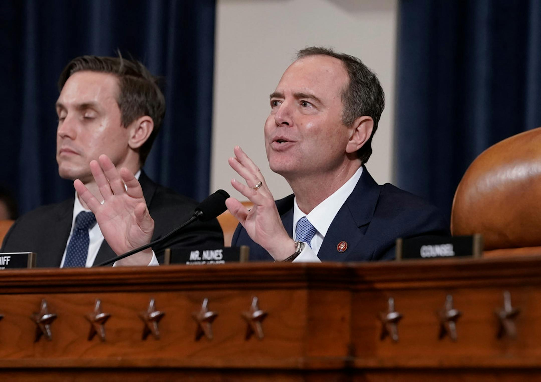 House Intelligence Committee Chairman Adam Schiff, D-Calif., with committee staffer Daniel Noble at left, makes impassioned remarks at the conclusion of a week of public impeachment hearings on President Donald Trump's efforts to tie U.S. aid for Ukraine to investigations of his political opponents, on Capitol Hill in Washington, Thursday, Nov. 21, 2019.