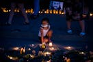 Tianna Epps, 4, of St. Paul paused at the area of the street where Philando Castile was killed while attending a candlelight vigil with her family at 