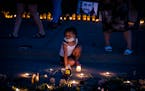 Tianna Epps, 4, of St. Paul paused at the area of the street where Philando Castile was killed while attending a candlelight vigil with her family at 