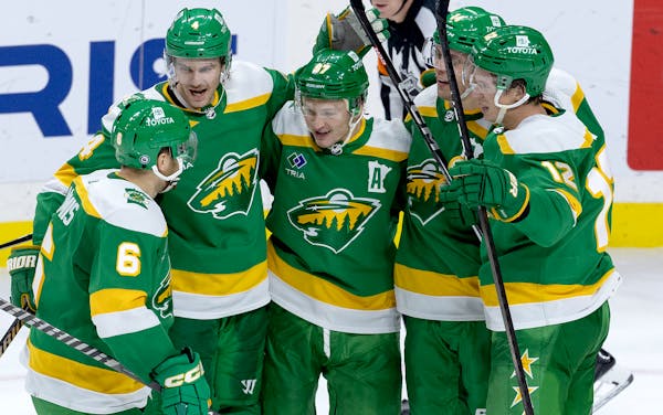 Kirill Kaprizov (97) rejoiced with his Wild teammates after he scored a third-period goal.