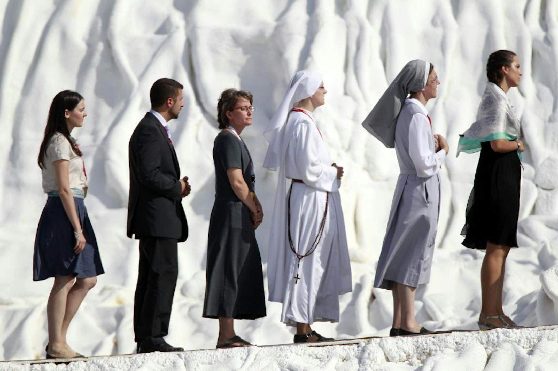 Worshipers line up to receive Holy Communion from Pope Benedict XVI during outside Madrid Sunday Aug. 21, 2011.