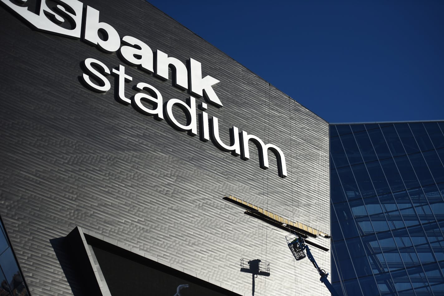 One zinc panel from U.S. Bank Stadium's problematic western prow fell to the ground early Monday while others have come loose again, leaving an absent horizontal strip of black panel from the glass facade to underneath the U.S. Bank Stadium logo.