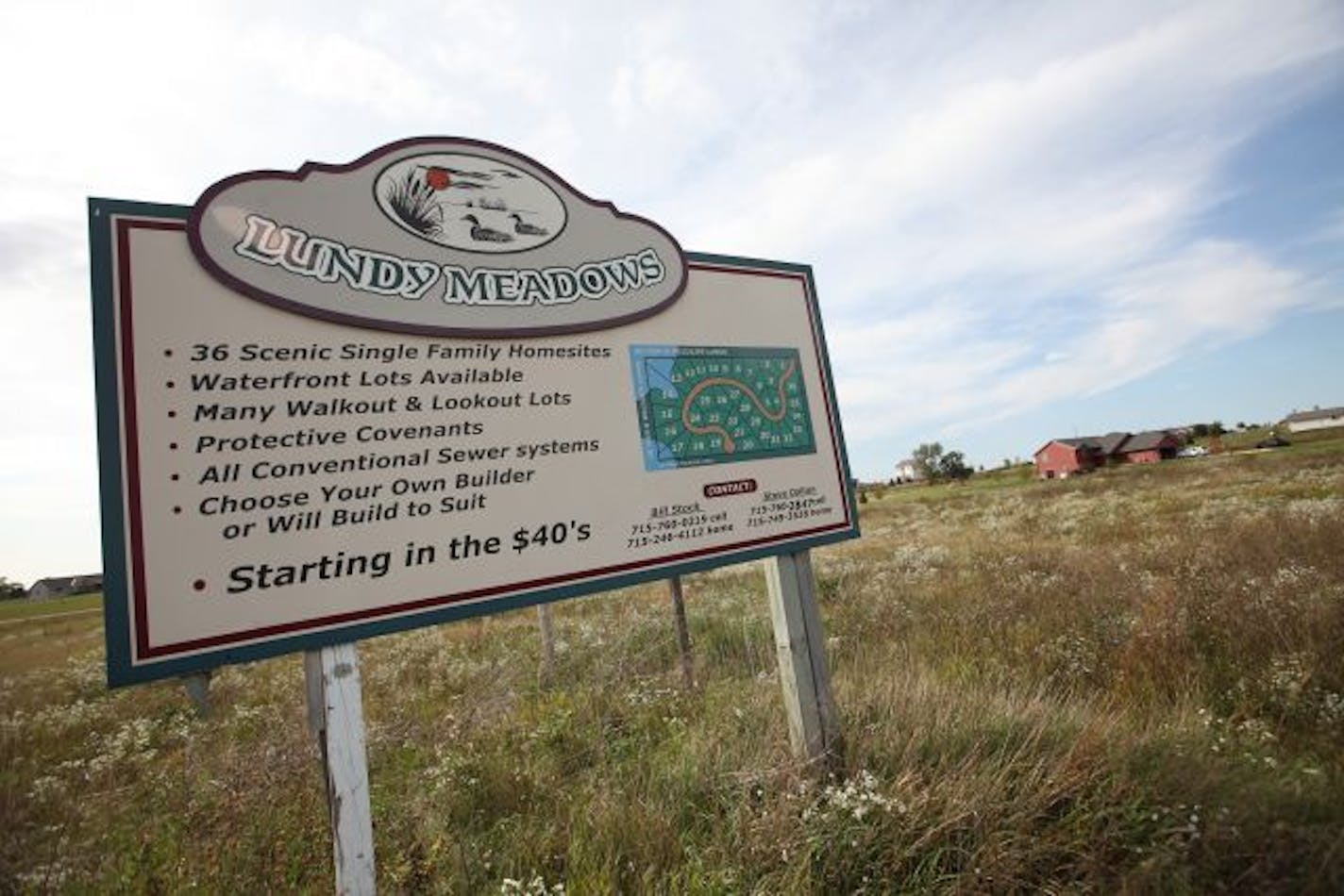 Signs for new housing developments are posted along Hwy. 65.