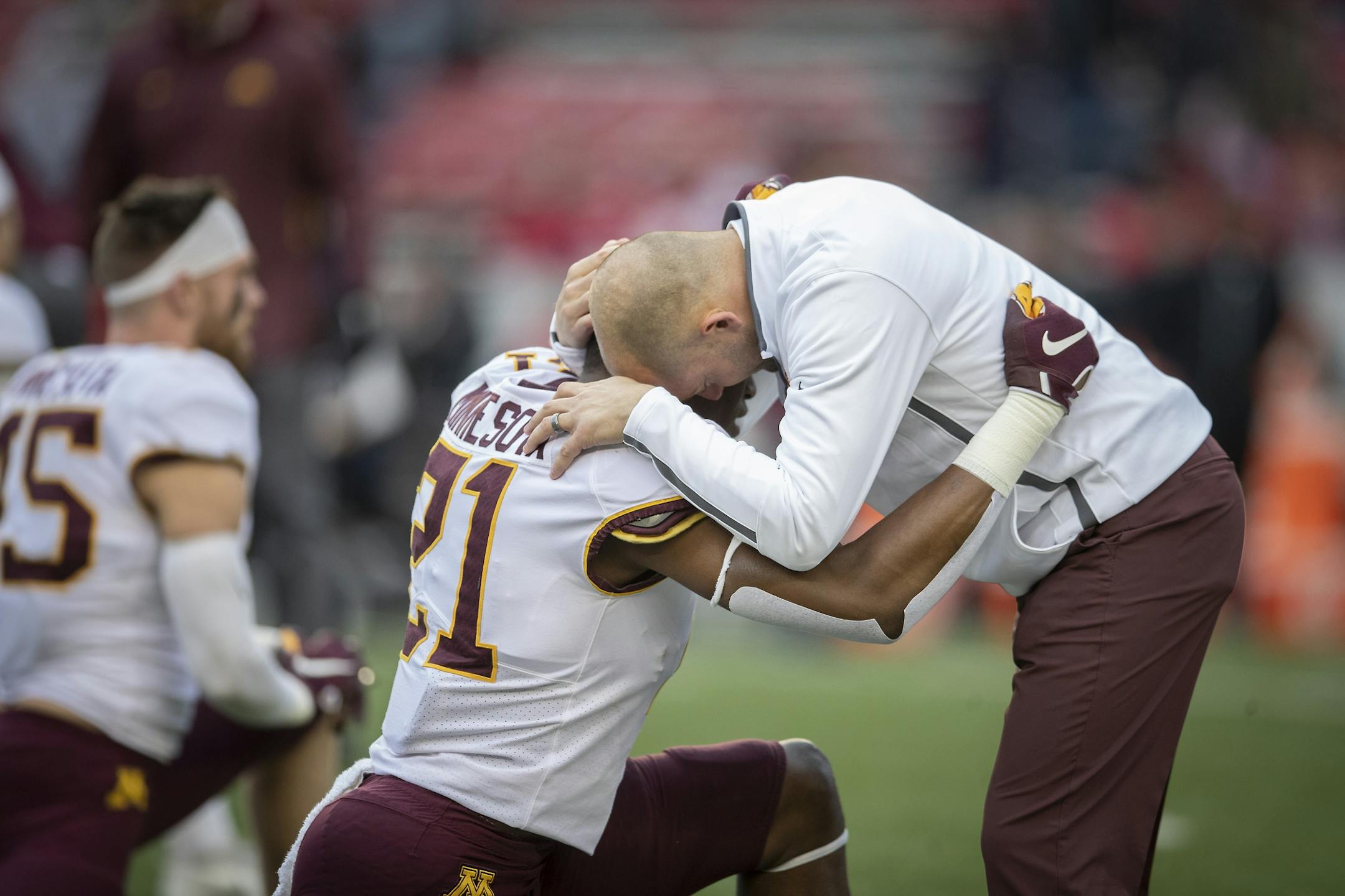 Minnesota's Head Coach P. J. Fleck took to the field to hug players including linebacker Kamal Martin before Minnesota took on Wisconsin at Camp Randall Stadium, Saturday, November 24, 2018 in Madison, Wis.