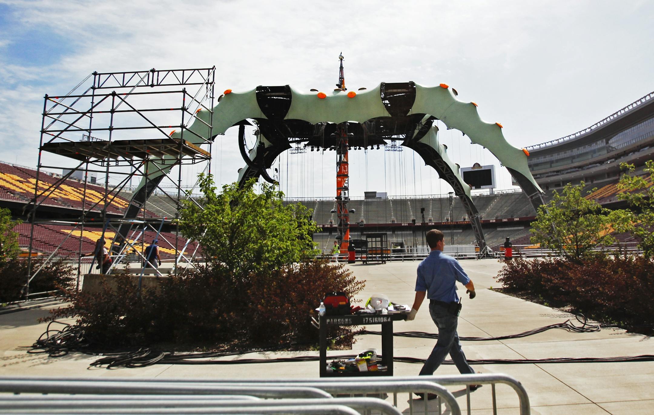 A worker pulled a cart in TCF Bank Stadium near the giant U2 360 degree tour set as final preparations took place Friday, July 22, 2011, for Saturday's concert at TCF Bank Stadium in Minneapolis.