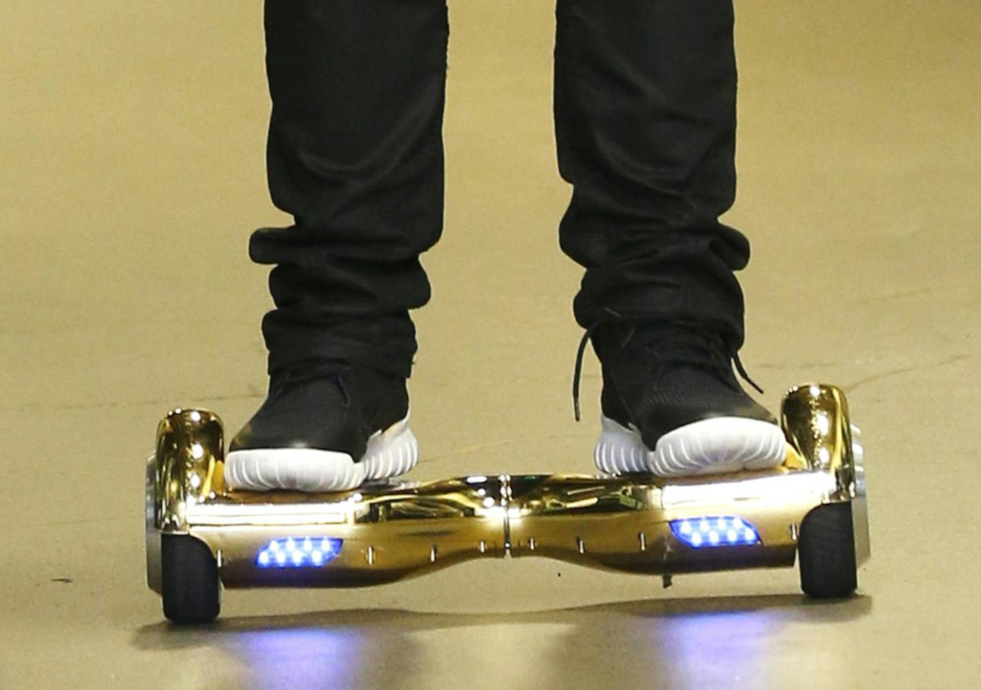 FILE - In this Sunday, Oct. 18, 2015 file photo, Seattle Seahawks wide receiver B.J. Daniels rides a hoverboard as he arrives for an NFL football game against the Carolina Panthers, in Seattle. Amazon is warning British customers that their hoverboards may be unsafe, the latest in a string of warnings about the popular scooters. Amazon says some of the boards it sold are unsafe because they have &#xec;a non-compliant U.K. plug" and should be disposed of at a recycling center. (AP Photo/Stephen B