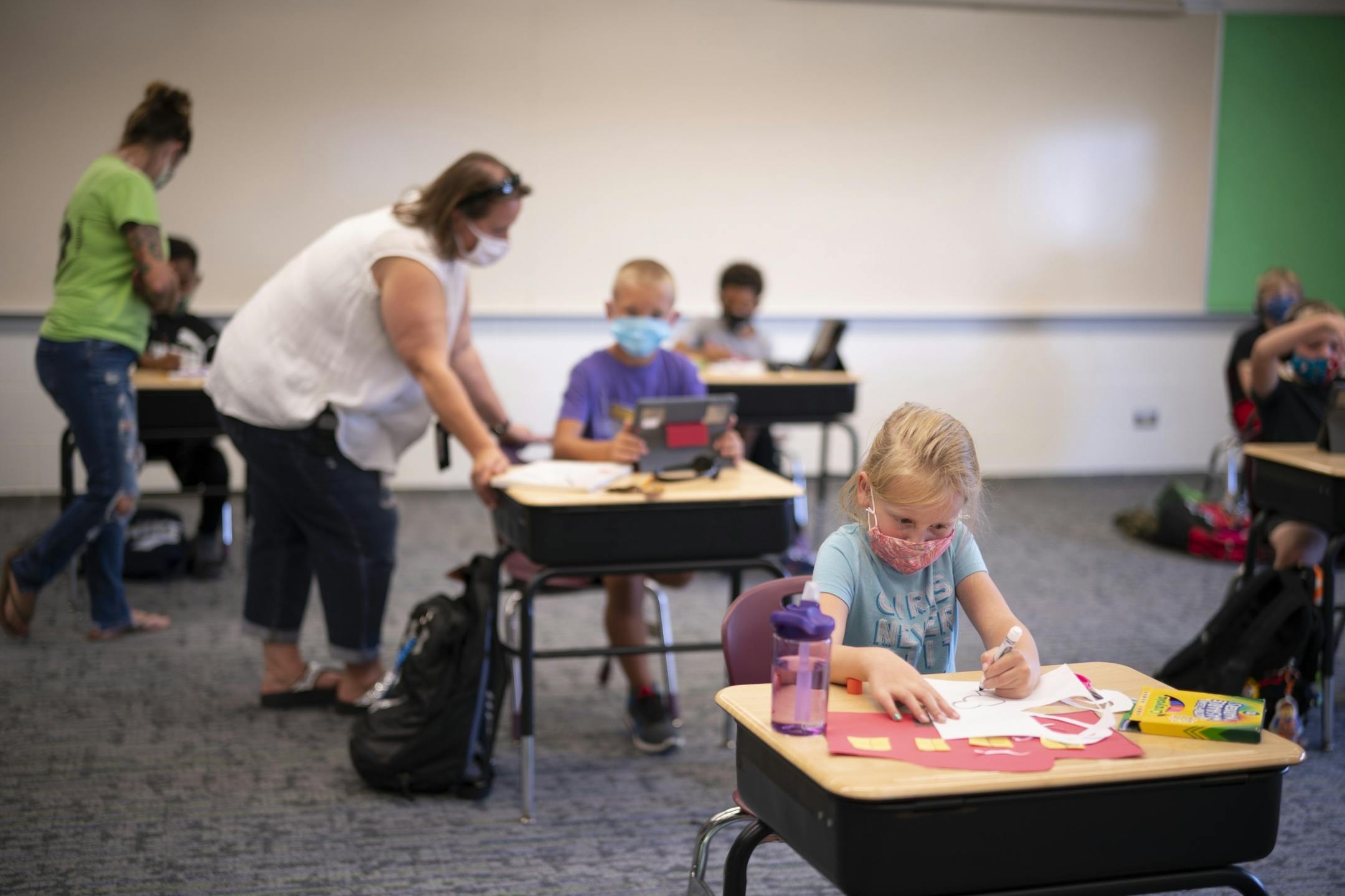 Second grade children of essential workers worked on school assignments or art under the direction of Jess Horn, left, and Mary Paulus Wednesday afternoon.