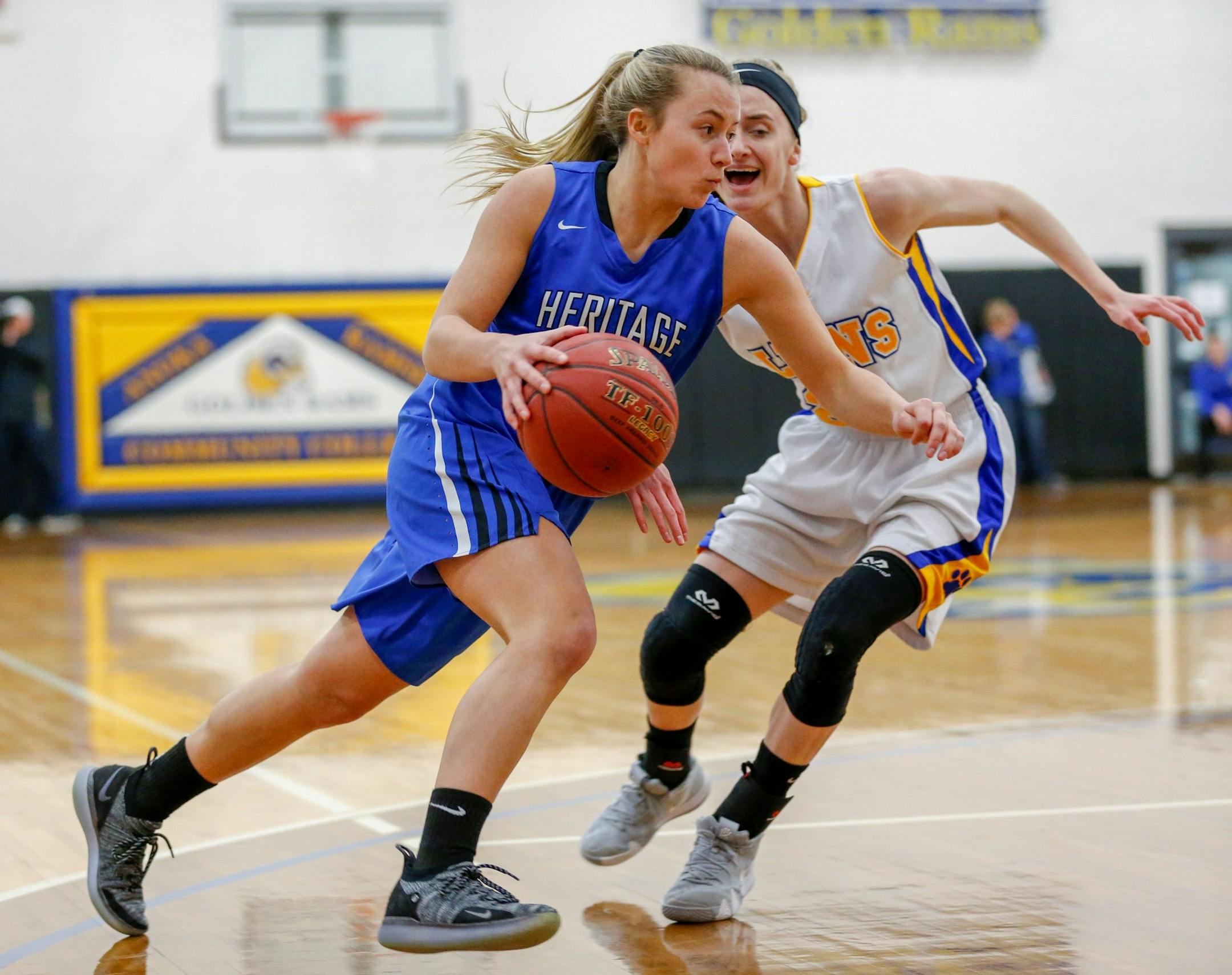Heritage Christian Academy's Taylie Scott drives to the basket around CHOF's Isabelle Carlson in the first half of Friday's Class1A Section 4 Final. Scott finished with 20 points for the Eagles in their 60-47 victory over the Lions. Photo by Jeff Lawler, SportsEngine