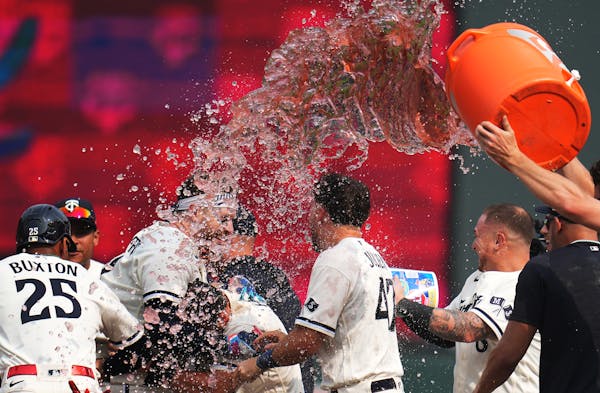 Twins players poured Gatorade on Minnesota Twins catcher Ryan Jeffers for hitting the winning RBI in the twelfth inning.
