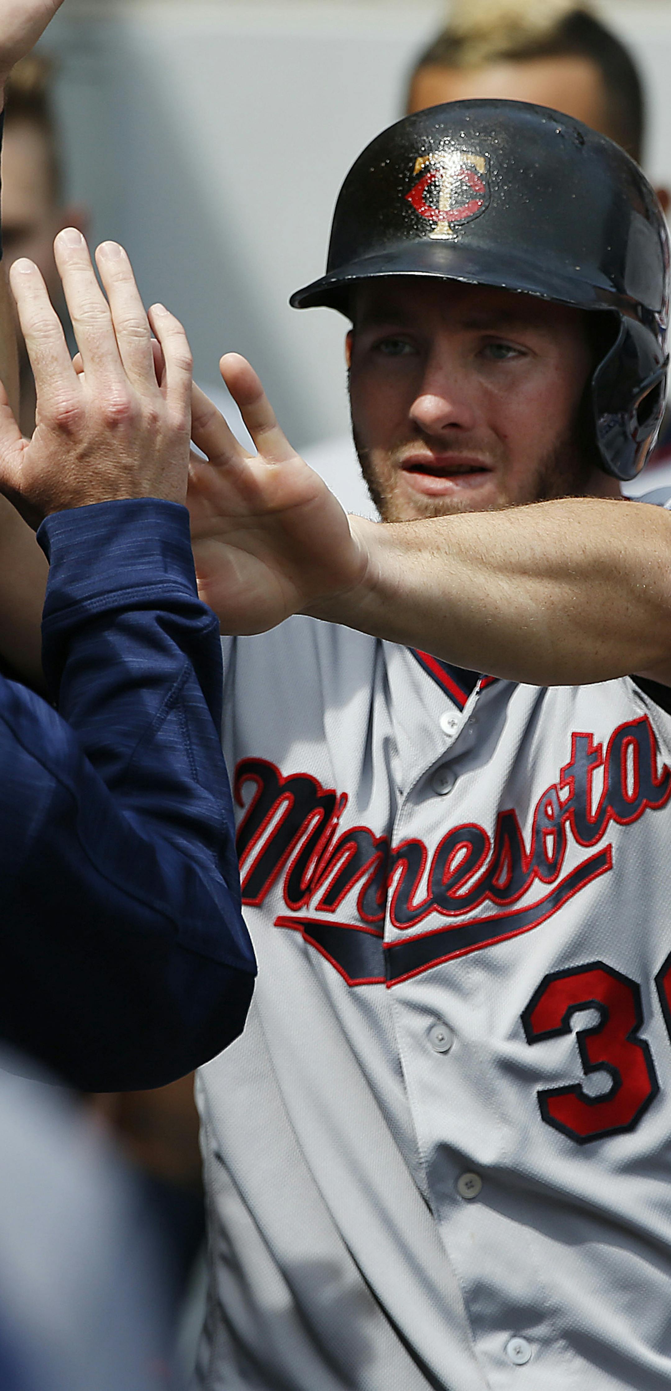 Minnesota Twins' Robbie Grossman (36) celebrates with teammates after scoring on a single by Joe Mauer during the third inning of a baseball game against the Chicago White Sox, Sunday, April 9, 2017, in Chicago. (AP Photo/Nam Y. Huh)