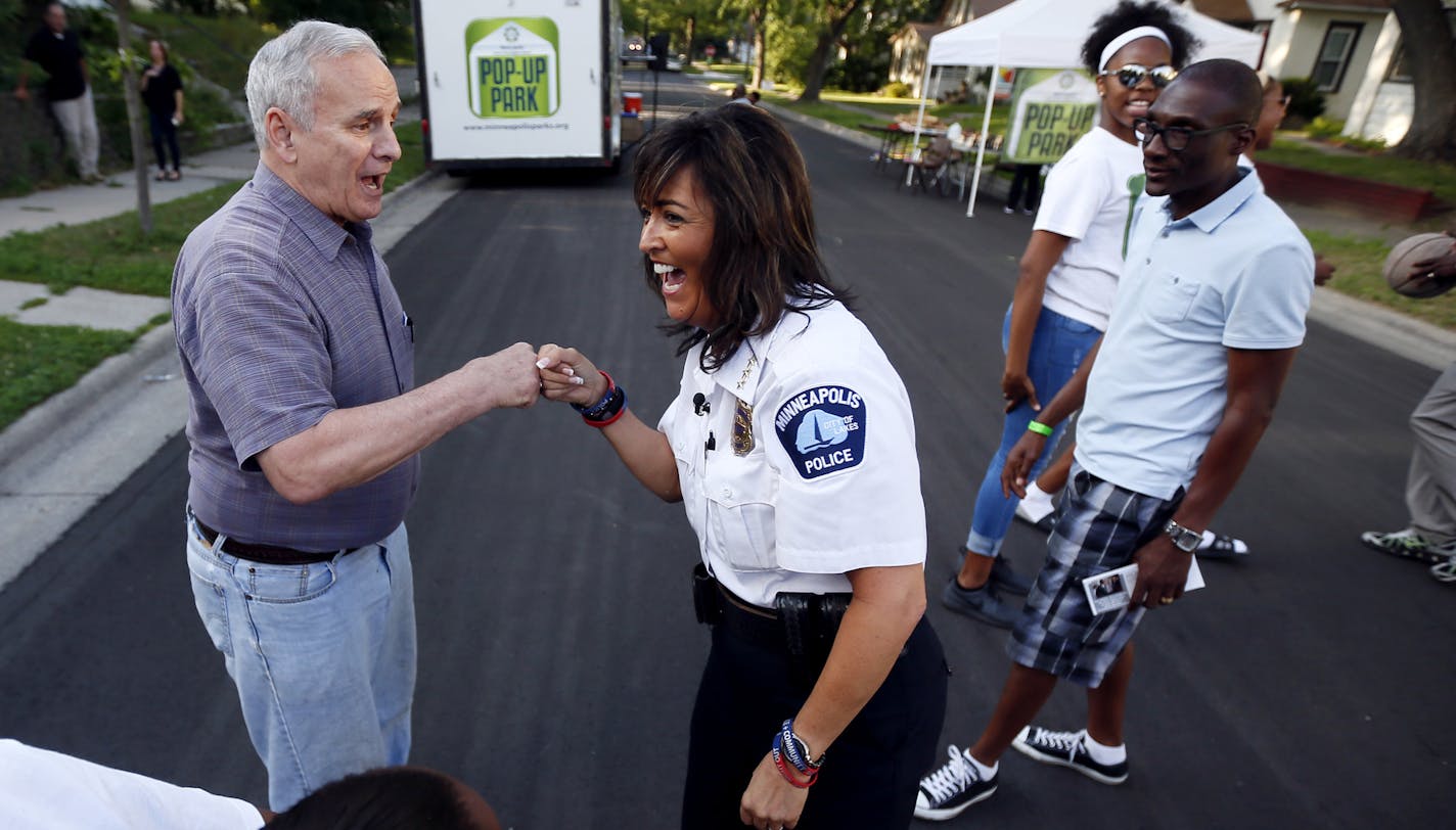 Minneapolis Police Chief Janee Harteau bumped firsts with Gov. Mark Dayton after making a basket at the National Night Out block party in the 3400 block of Knox Avenue N. on Tuesday.