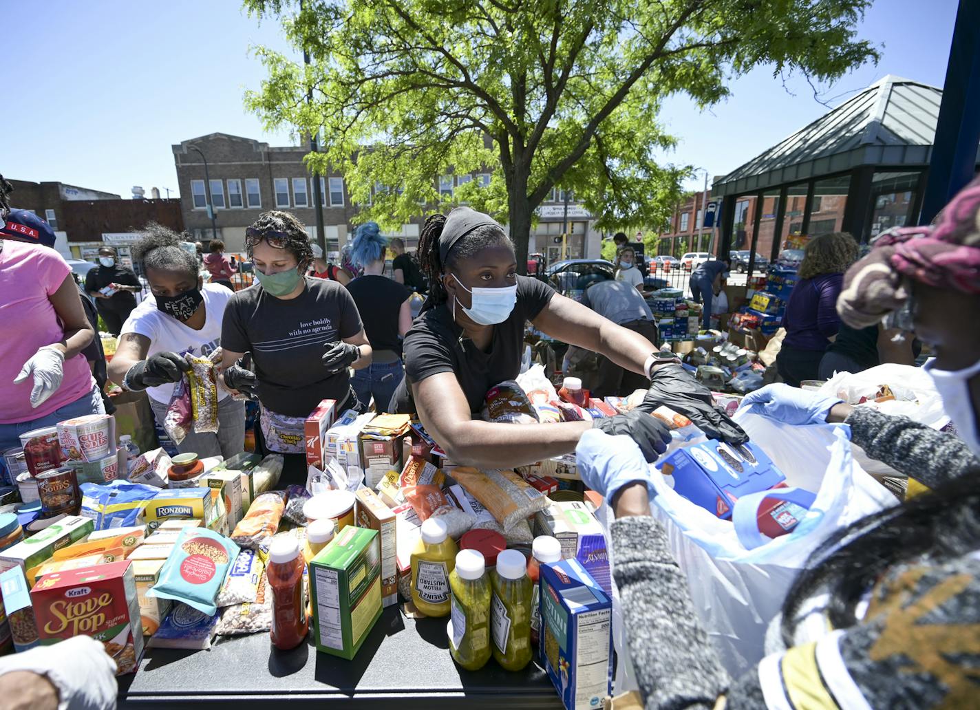 Cathy Burns, an employee with the City of Minneapolis, handed out food items during while volunteering in north Minneapolis Saturday. ] aaron.lavinsky@startribune.com Protests continued in the wake of George Floyd's death in police custody on Saturday, May 30, 2020 in Minneapolis, Minn.