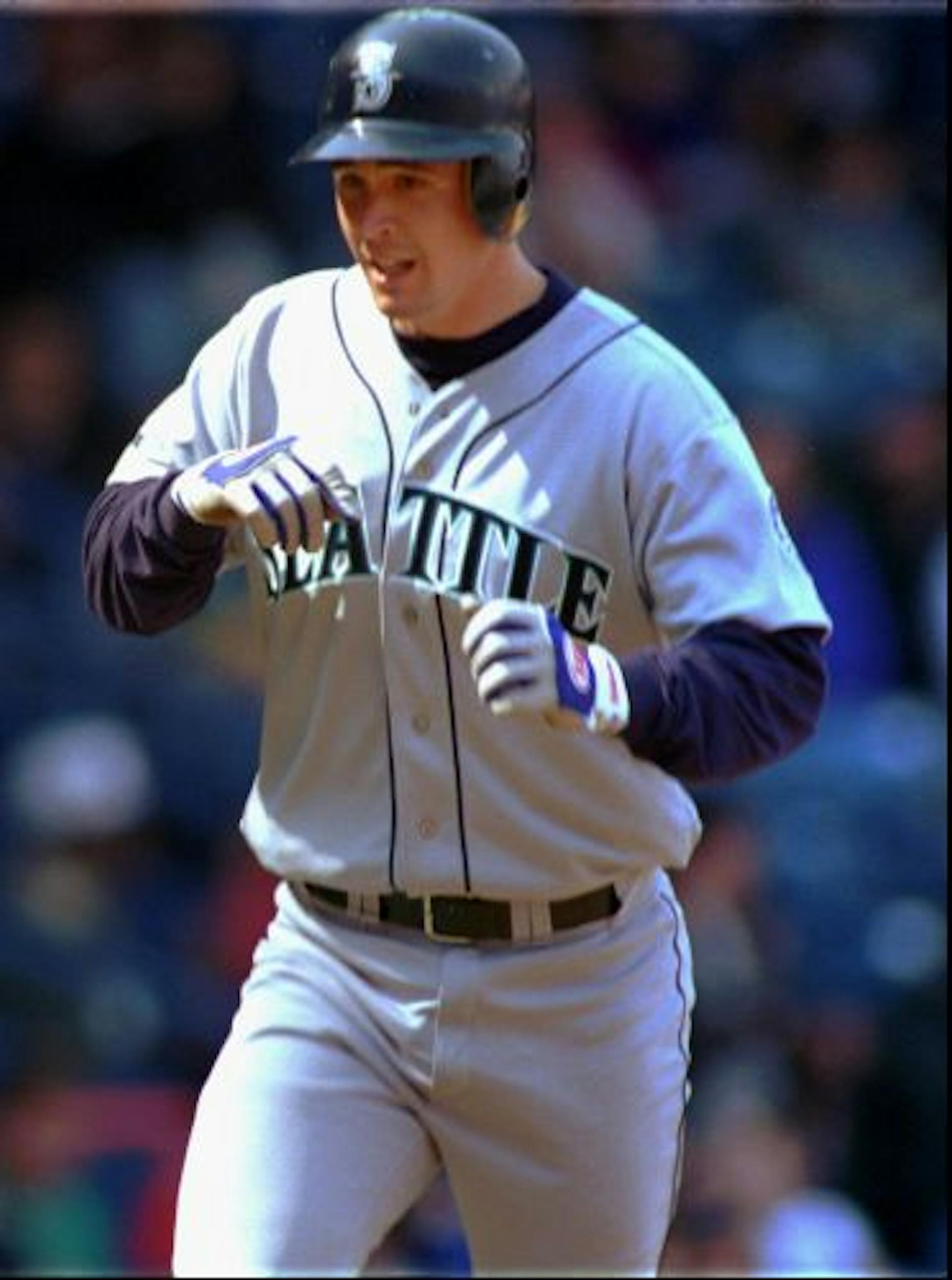 Seattle Mariners' Dan Wilson trots home in the eighth inning after his third home run against the Detroit Tigers on Thursday, April 11, 1996, in Detroit. The Mariners' 9-1 win against the Tigers ended their nine-game losing streak at Tiger Stadium.