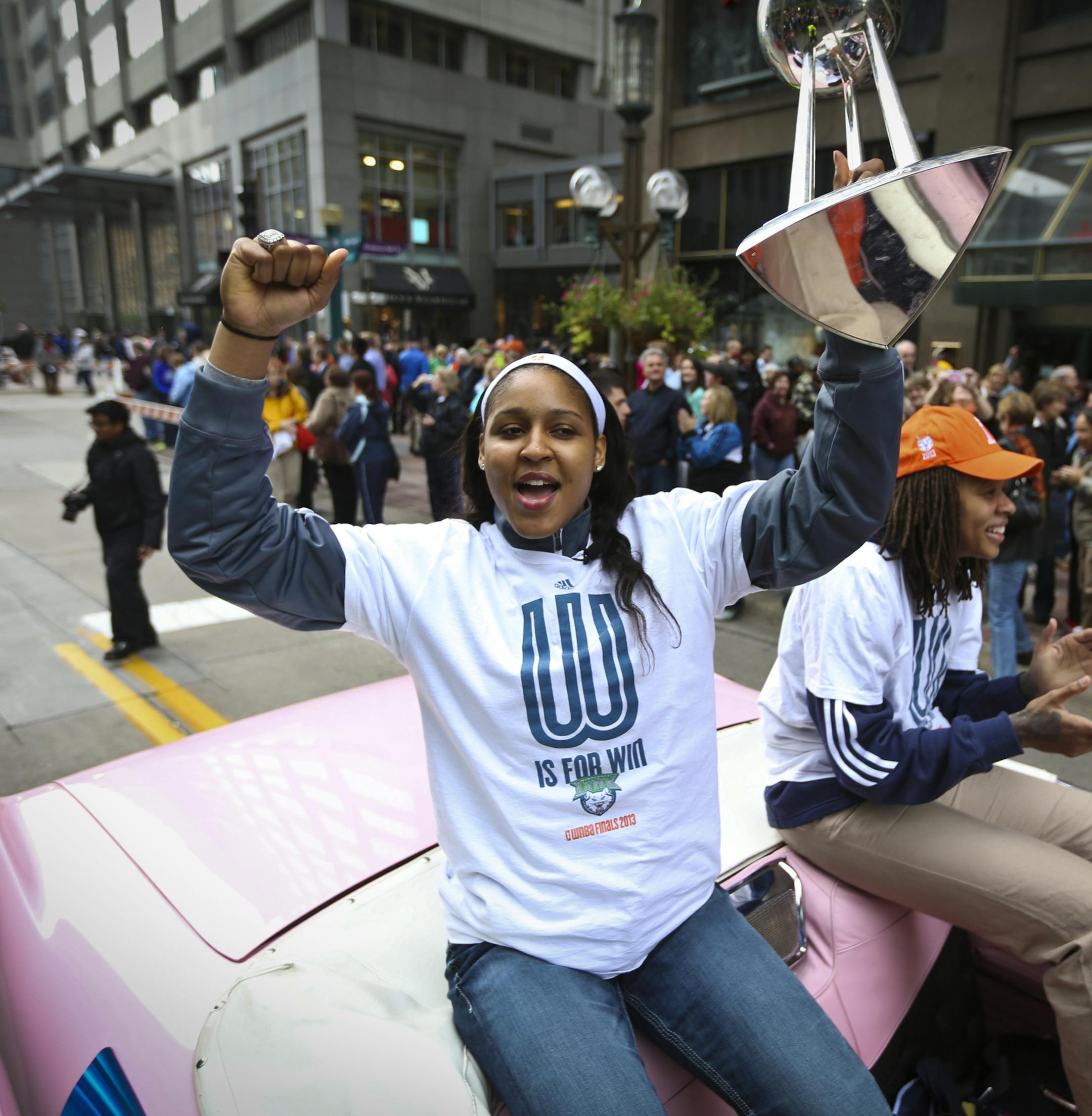 Lynx player Maya Moore held up the championship trophy as she rode a float with Seimone Augustus during a championship celebration parade for the WNBA champions on Monday, October 14, 2013, through downtown Minneapolis, Minn.] RENEE JONES SCHNEIDER &#x2022; reneejones@startribune.com