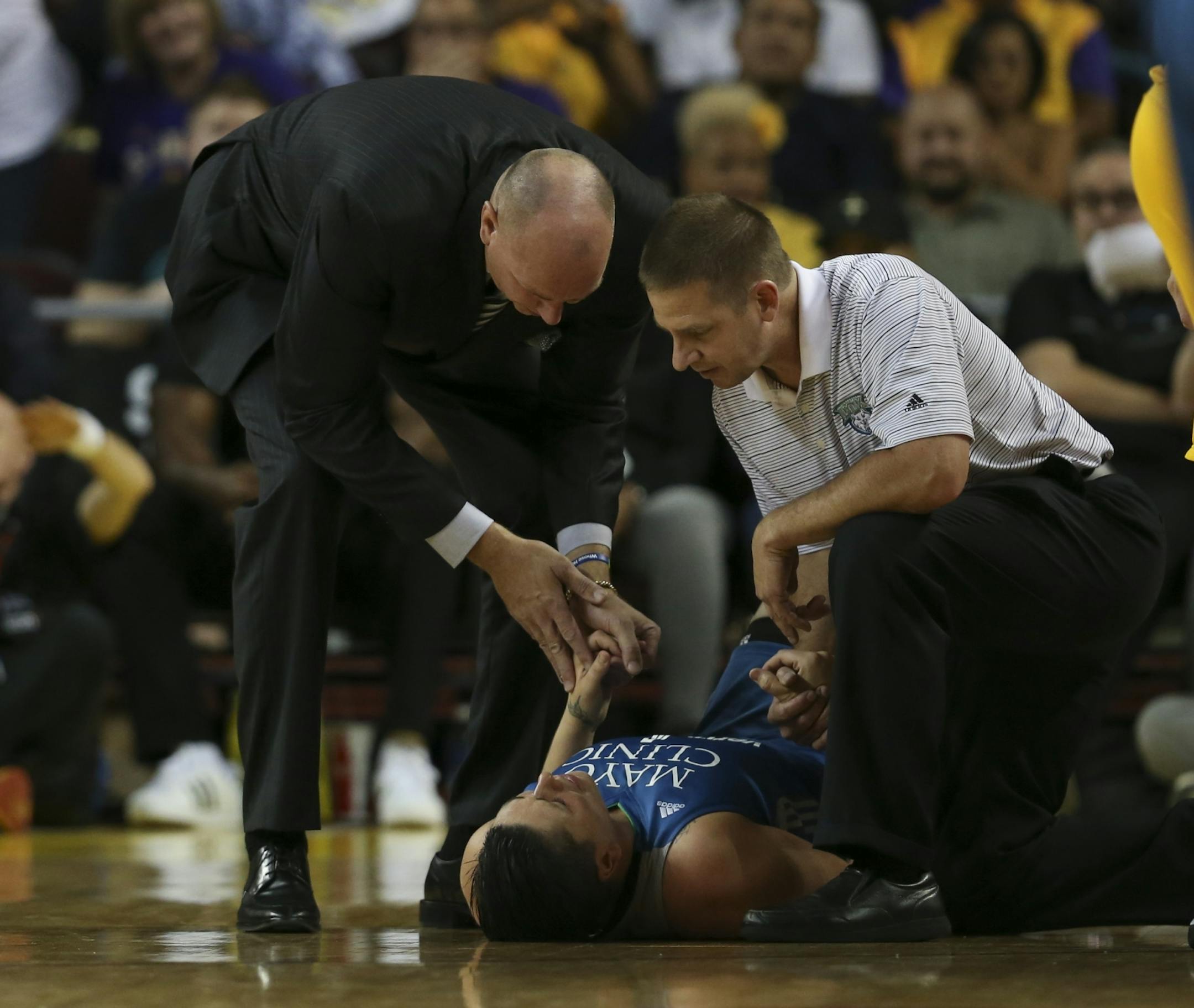 Lynx trainer Chuck Barta and assistant coach Jim Petersen attended to injured Lynx center Janel Mcarville late in the third quarter. She was taken to the locker room when she was able to get up.
