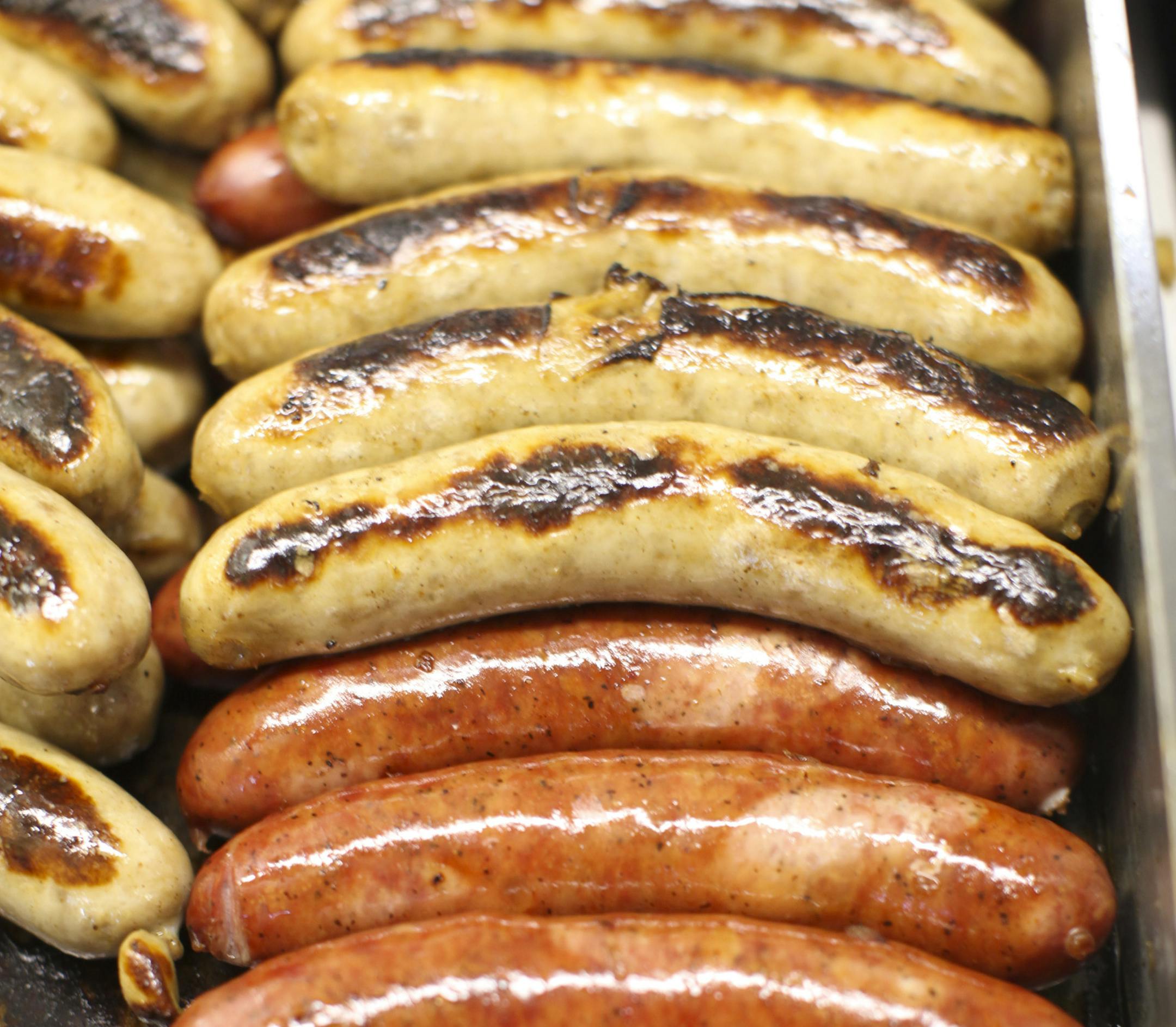 JEFF WHEELER • jeff.wheeler@startribune.com MINNEAPOLIS - 7/16/10 - Kramarczuk's Polish sausage and bratwurst are found at two stands on the main concourse level of Target Field. IN THIS PHOTO: ] Sausages on the grill at one of the Kramarczuk's food stands Friday night.