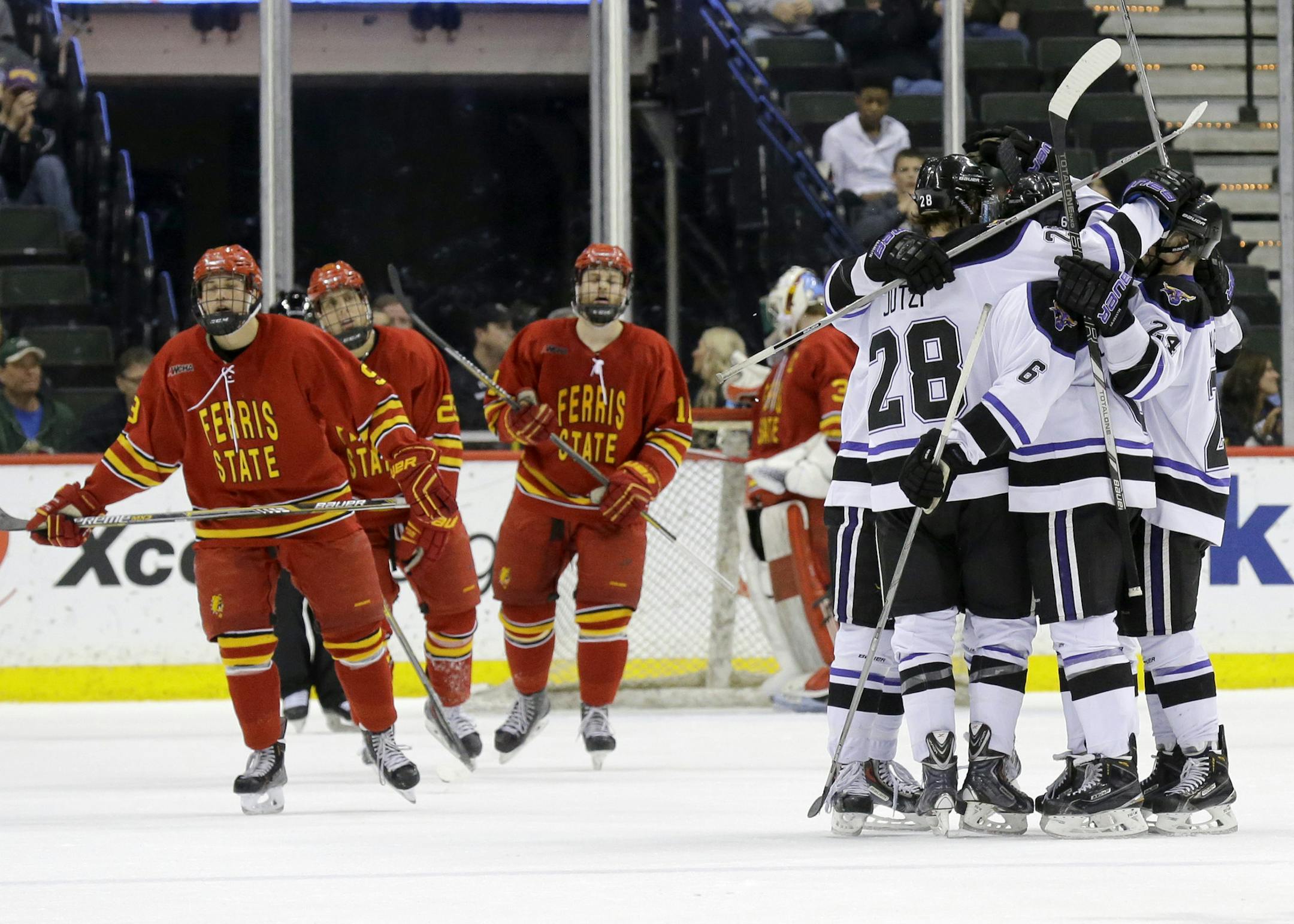 Minnesota State Mankato players congratulate forward Brad McClure after his second goal against Ferris State during the second period of a WCHA Final Five college semifinal hockey game in St. Paul, Minn., Friday, March 20, 2015. Minnesota State Mankato won. (AP Photo/Ann Heisenfelt)