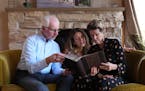 David McNally, his wife, Cheryl Harms Hauser, and her daughter Wendy Longacre Brown flipped through a photo album. Two years ago, Hauser was diagnosed