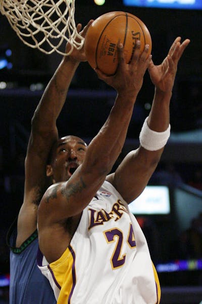 Los Angeles Lakers' Kobe Bryant gets fouled by Minnesota Timberwolves' Mark Blount while scoring two points in the first quarter of an NBA basketball 