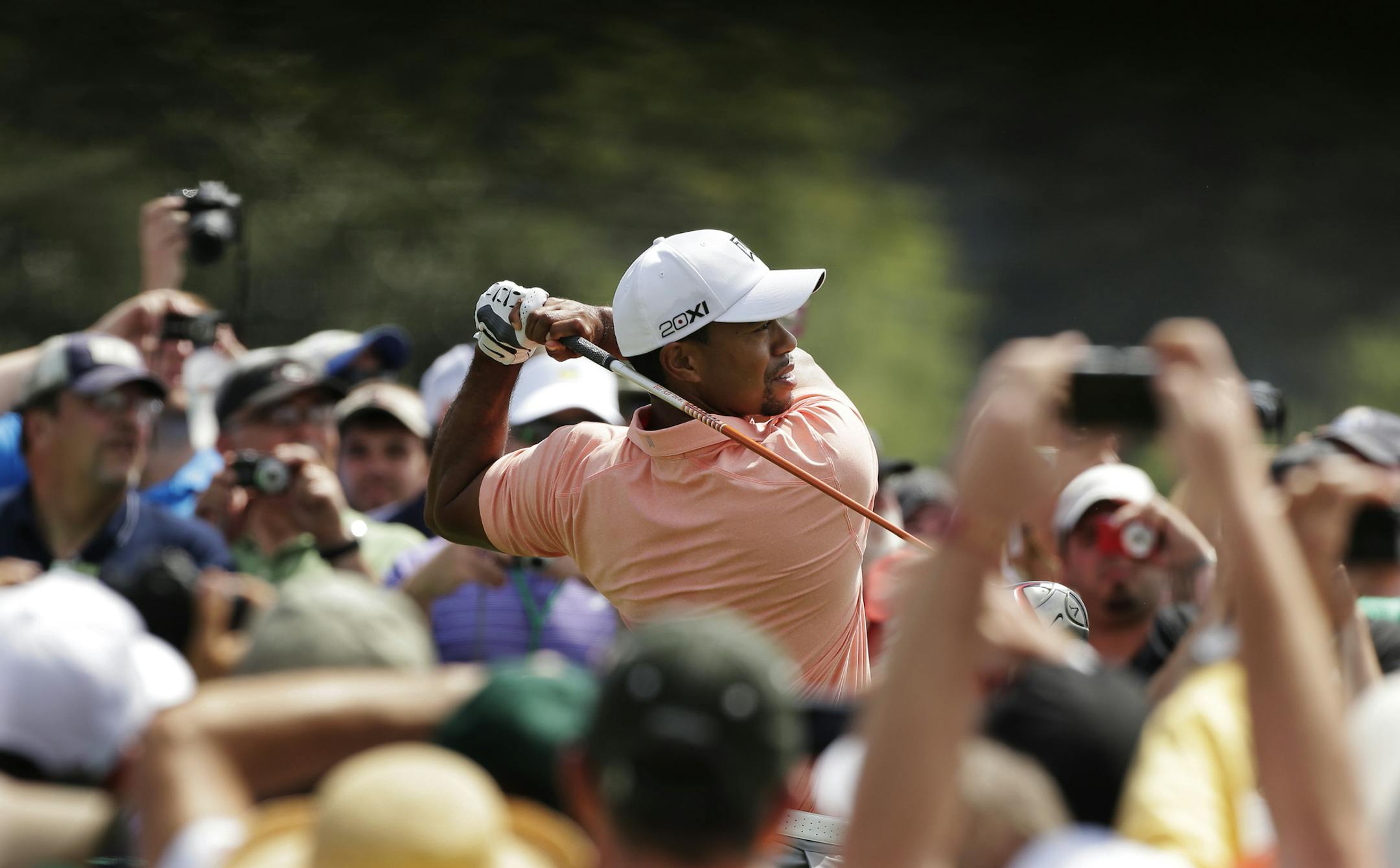 Tiger Woods tees off on the first hole during a practice round for the Masters golf tournament Tuesday, April 9, 2013, in Augusta, Ga. (AP Photo/Charlie Riedel)