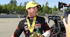 In this photo provided by the NHRA, Steve Torrence celebrates after notching his fifth victory Top Fuel of the year at the annual NHRA New England Nat