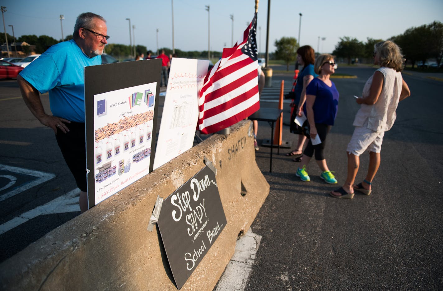 Curt Olson hung posters at a junior high calling for the school board in Shakopee to step down.