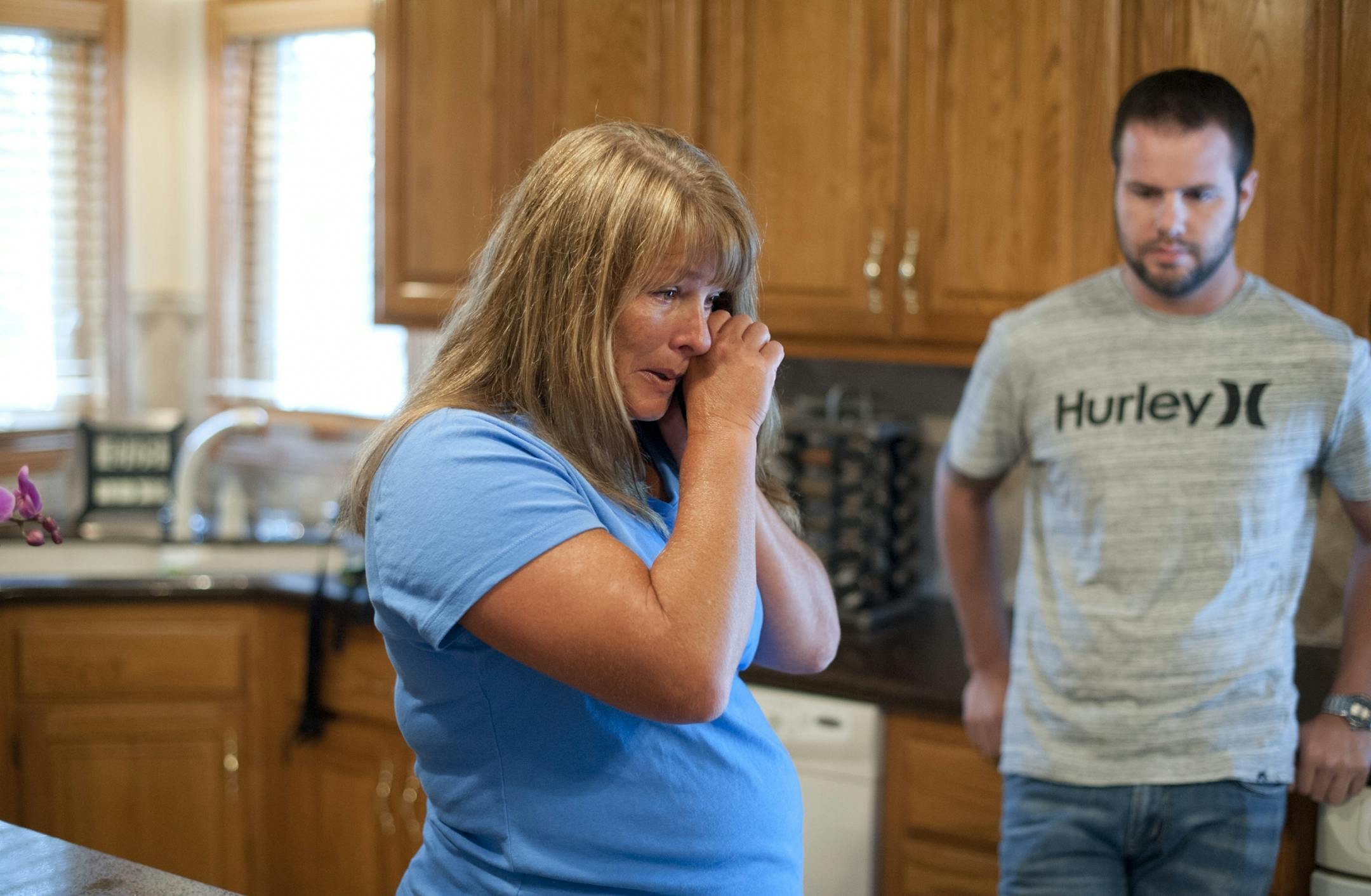 Denise Shannon reacted with joy while talking on the phone with her father after hearing news of the Minnesota Supreme Court ruling. Her son Brandon was at right.