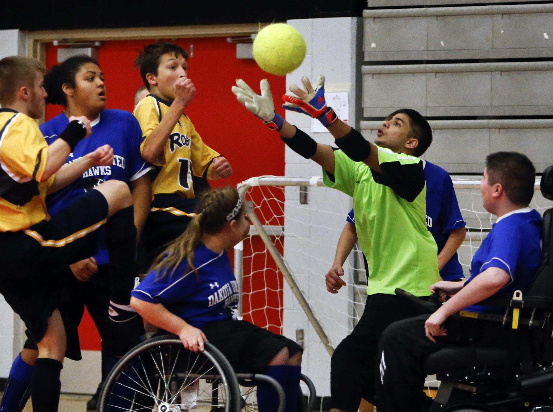 Robbinsdale/Hopkins/Mound Westonka and Dakota United squared off in adapted soccer state championships in the physically impaired division Saturday, Nov. 16, 2013, at Stillwater High in Stillwater, MN. Here, Dakota United goalie Anthony Vervais can't come up with the stop as Robbinsdale's Joe Dubisar (middle yellow) scores during Robbinsdale's 5-4 win.](DAVID JOLES/STARTRIBUNE) djoles@startribune.com Robbinsdale/Hopkins/Mound Westonka and Dakota United squared off in adapted soccer state champio