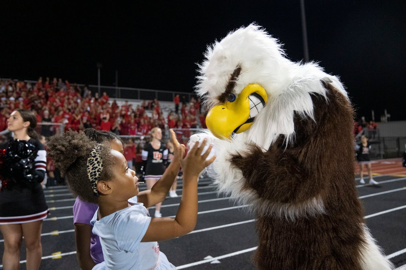 The Eden Prairie eagle mascot greets young fans in the fourth quarter of the game against Lakeville South Friday, September 16, 2022 at Eden Prairie High School in Eden Prairie, Minn. ]